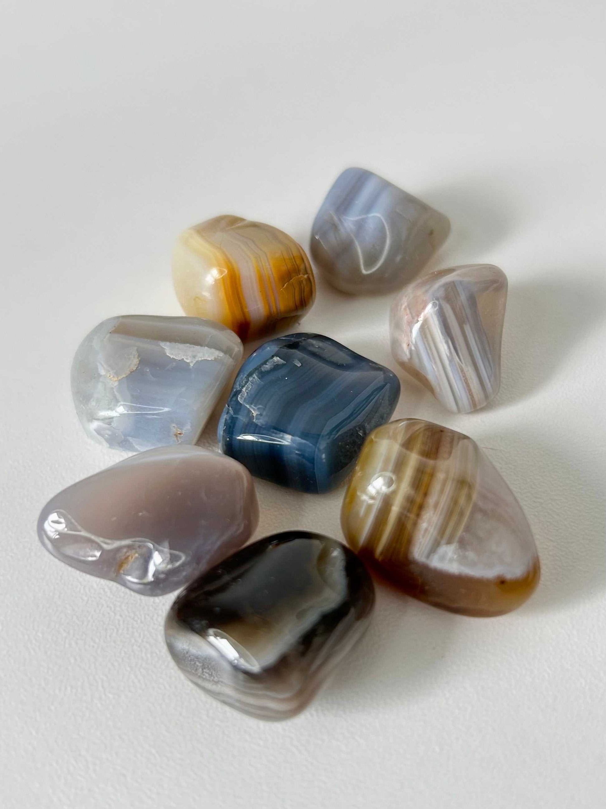 Assorted Banded Agate Healing Stones in various earthy tones, perfect for crystal collectors and holistic energy practices.