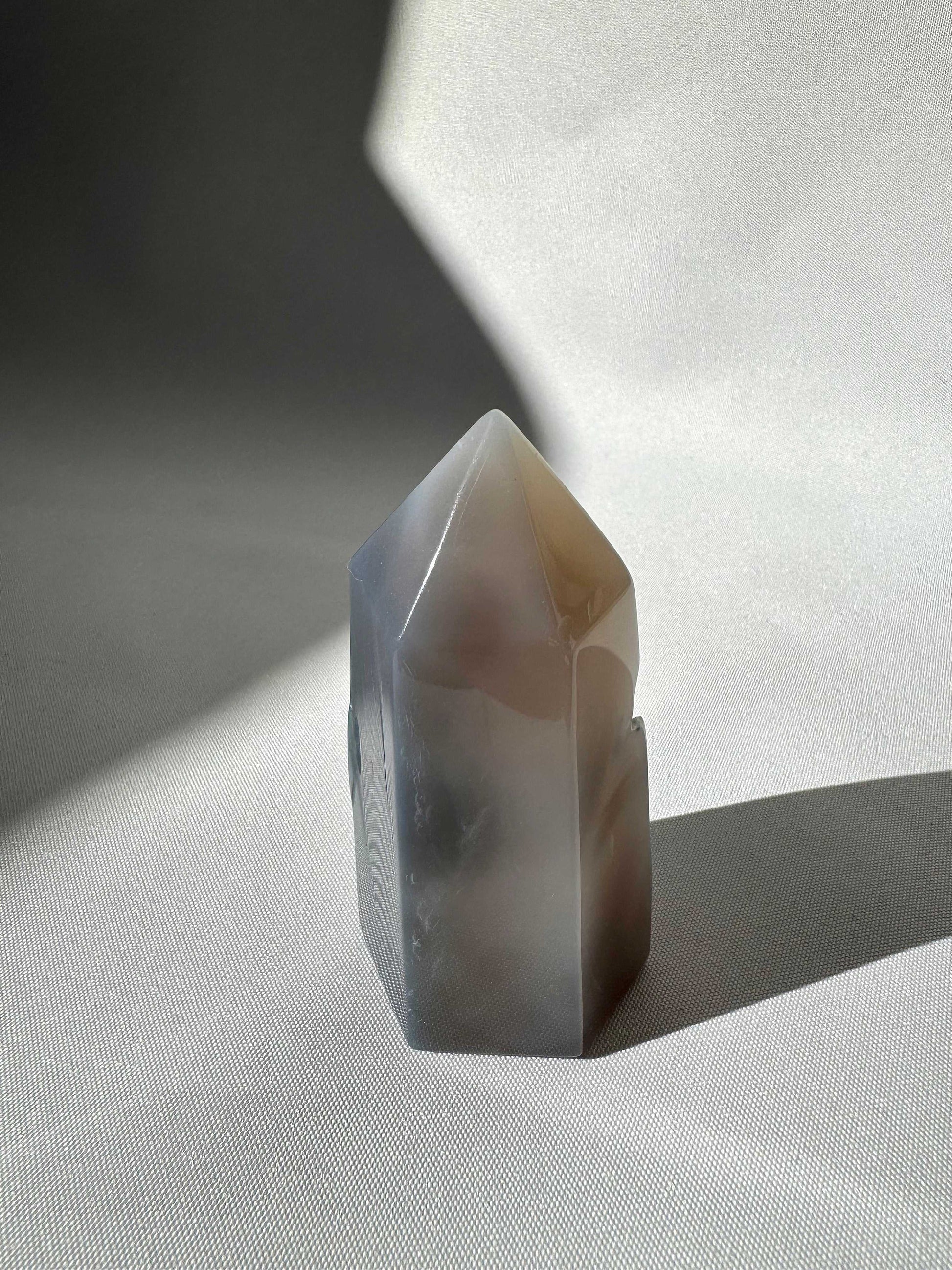 Grey Agate Crystal Point #2 featuring a sleek, freeform tower shape, used for grounding energy and decorative rock and fossil collections.