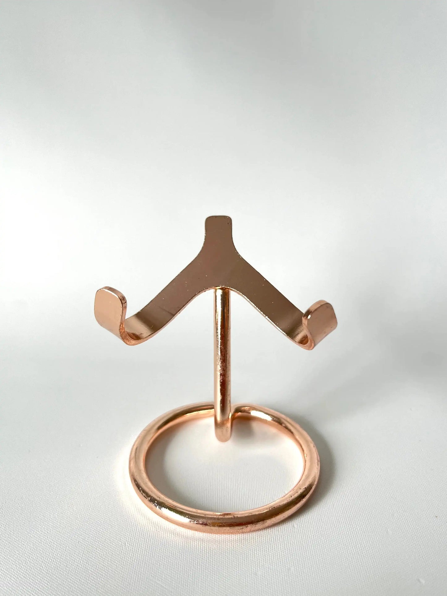 Rose gold crystal display stand with symmetrical curved arms and sturdy round base, designed for stylish crystal presentation | Bespoke Crystals NZ