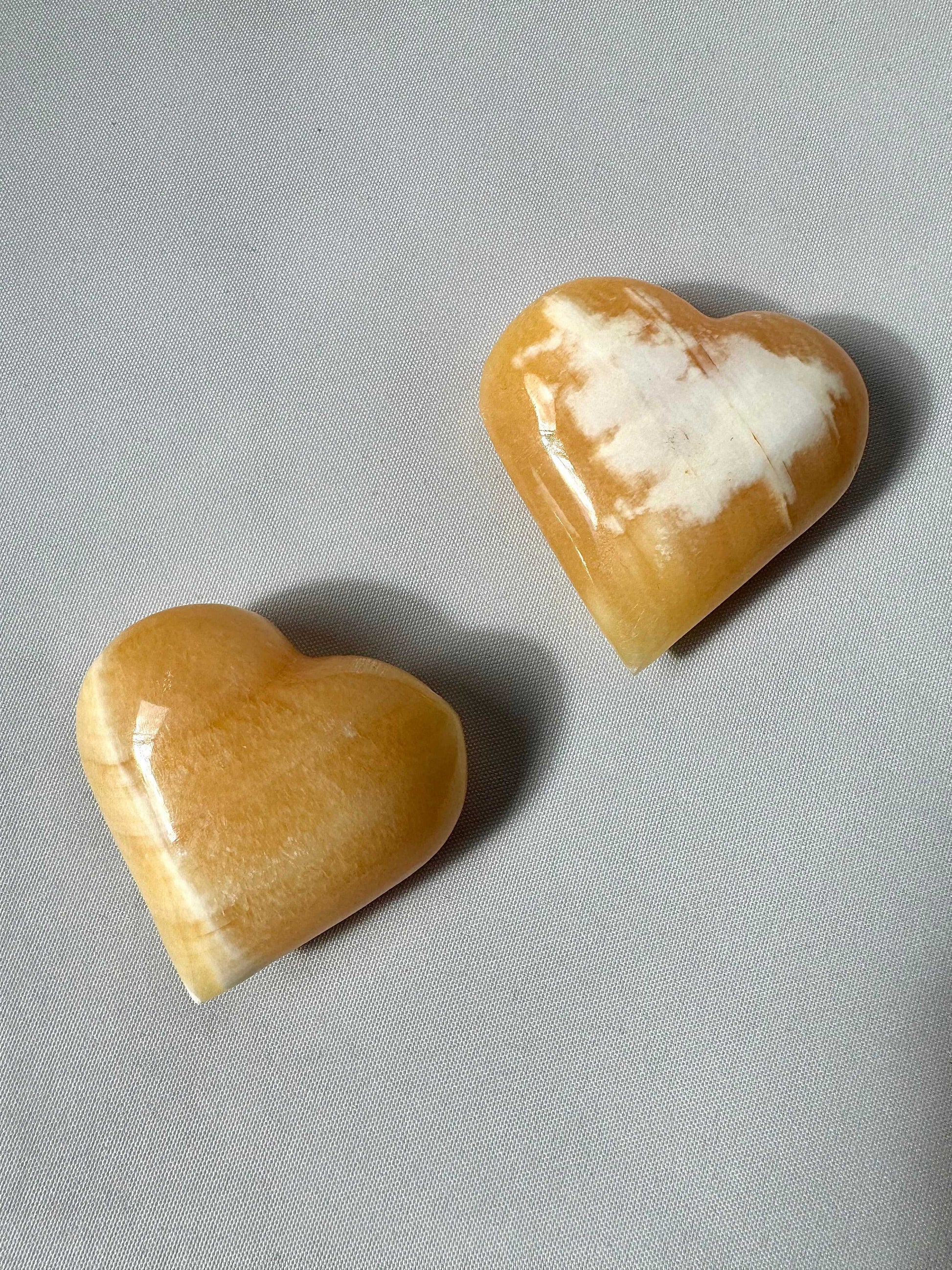 Two Orange Calcite Crystal Hearts | Bespoke Crystals | showcasing natural patterns and vibrant colour for decorative or spiritual use.