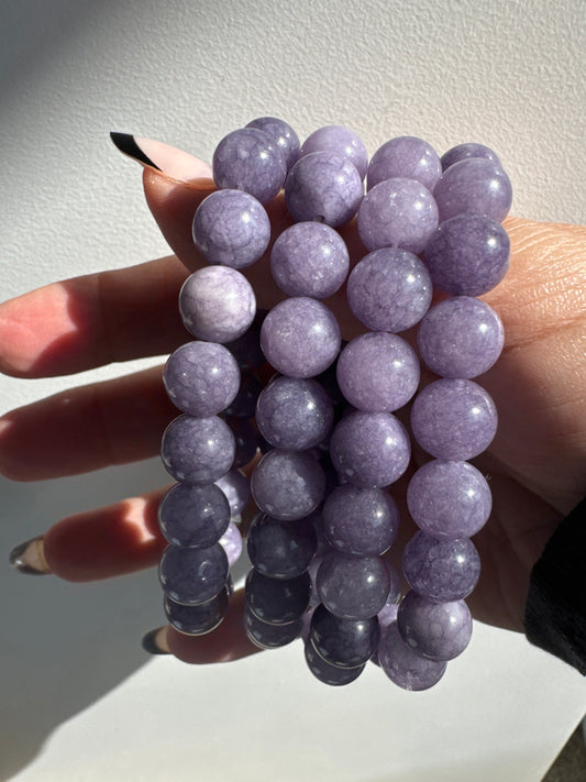 Lavender Jade Crystal Bracelets 10mm featuring polished round beads in a soft purple hue, ideal for healing and spiritual connection jewelry.