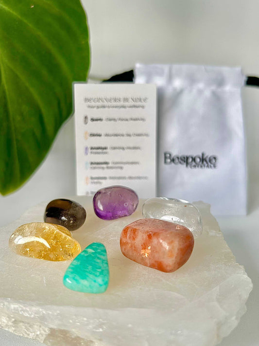 Beginners Bundle - Crystals for Beginners Kit featuring six polished tumble stones including Amethyst, Citrine, and Amazonite on a white selenite slab.