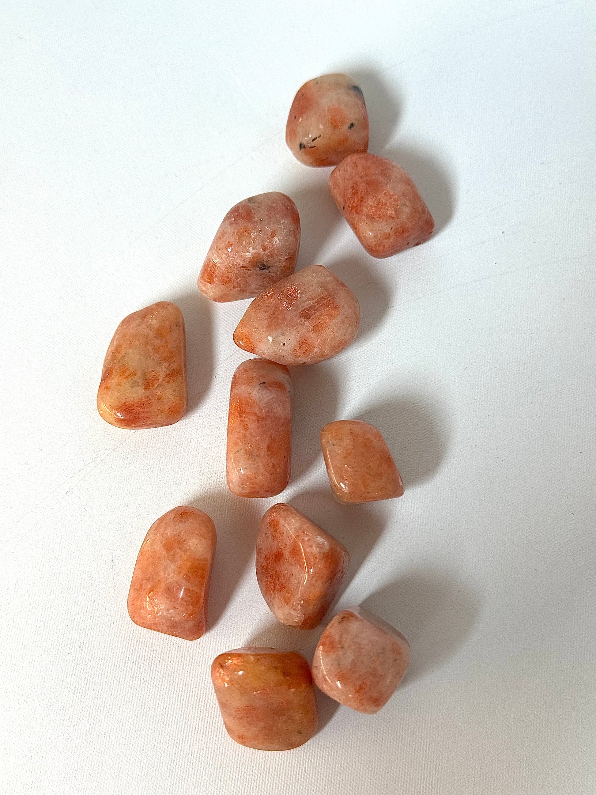 Sunstone Tumble Stone - Shop Online | Bespoke Crystals. A collection of smooth, peach-toned sunstones perfect for collectors and spiritual energy work.