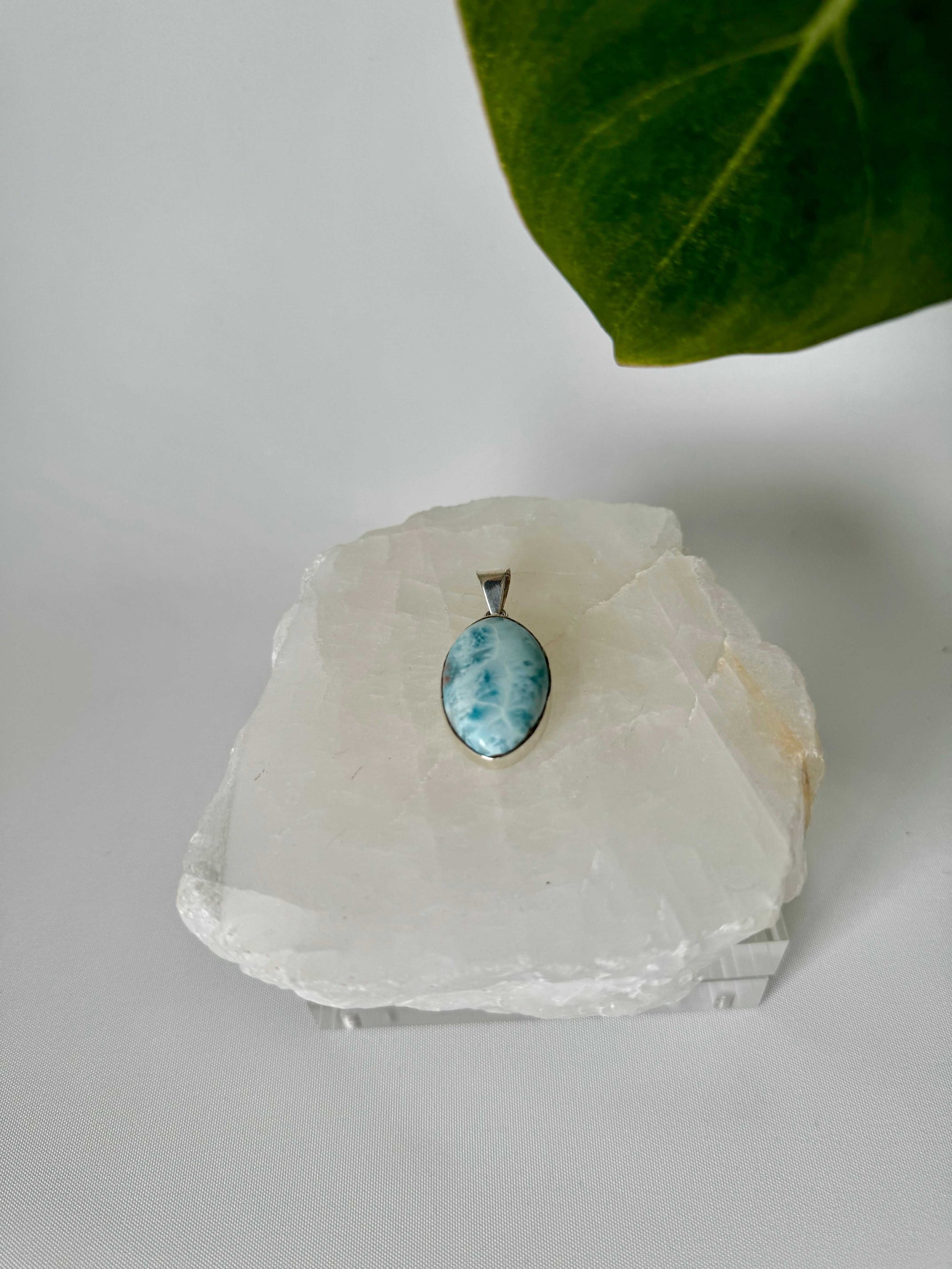 Larimar Crystal Pendant - Peace & Clarity , showcasing its ocean-blue hues and silver setting for healing energy Crystal Jewellery NZ