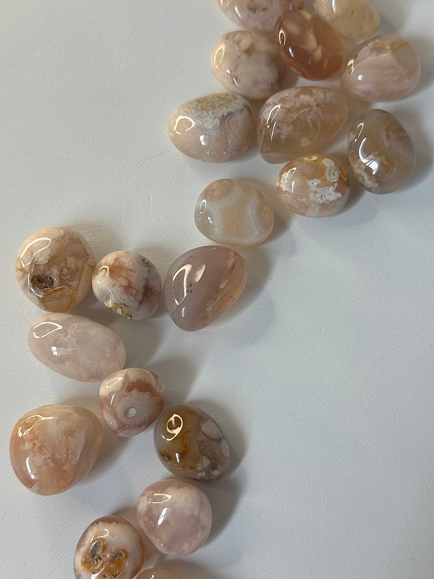 Assorted Flower Agate tumble stones promoting growth and healing. Explore online crystal shop for bespoke stones that support heart chakra energy.