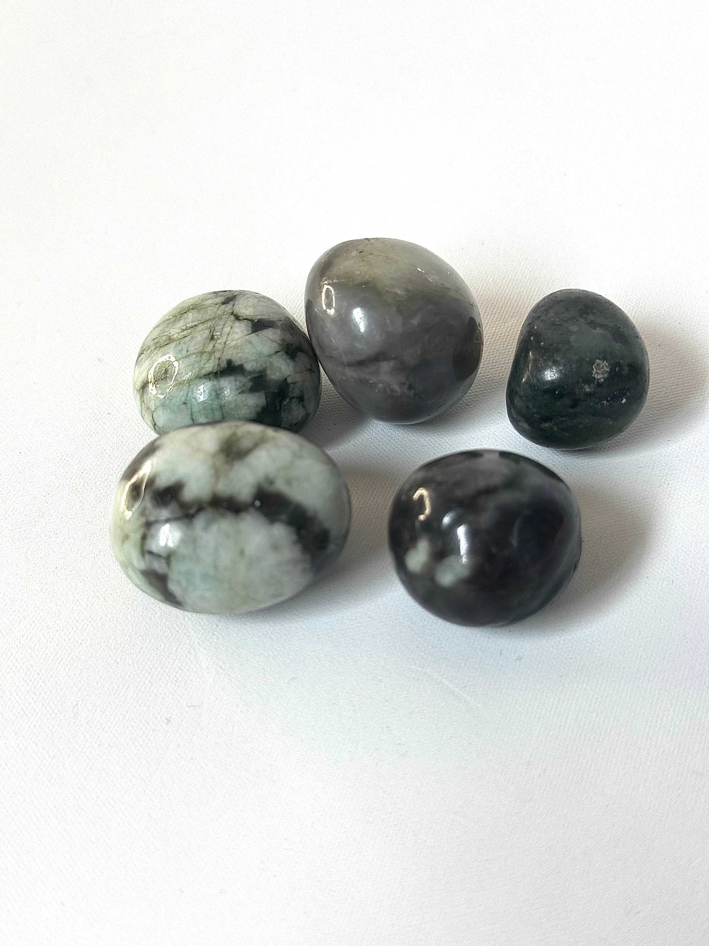 Polished Emerald Crystal Tumble Stones | Bespoke Crystals in varying shades of green and grey, collectible rocks for crystal enthusiasts.