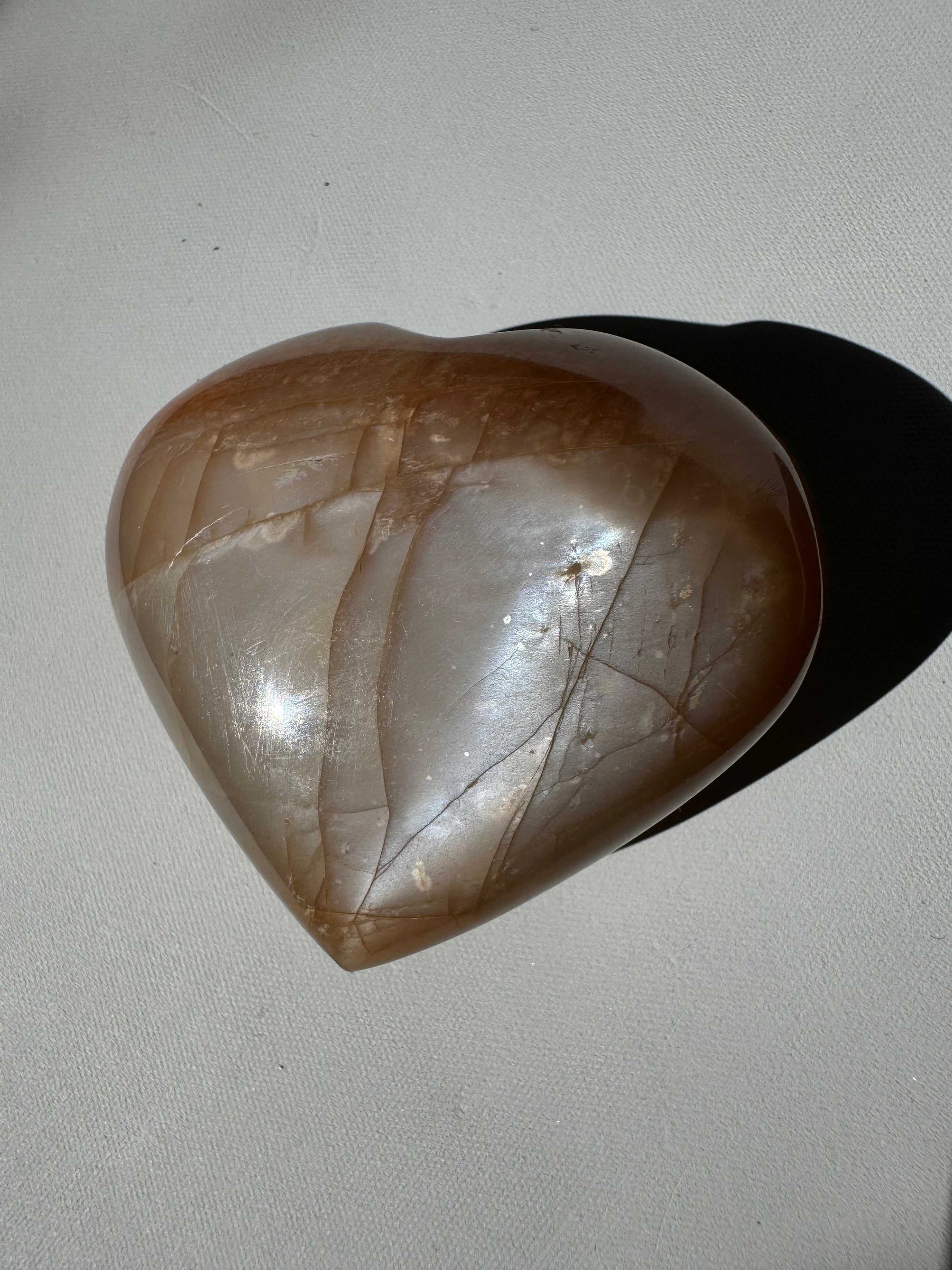 Peach Moonstone Heart #5 with natural shimmer, perfect for enhancing emotional well-being and spiritual energy in crystal collections.