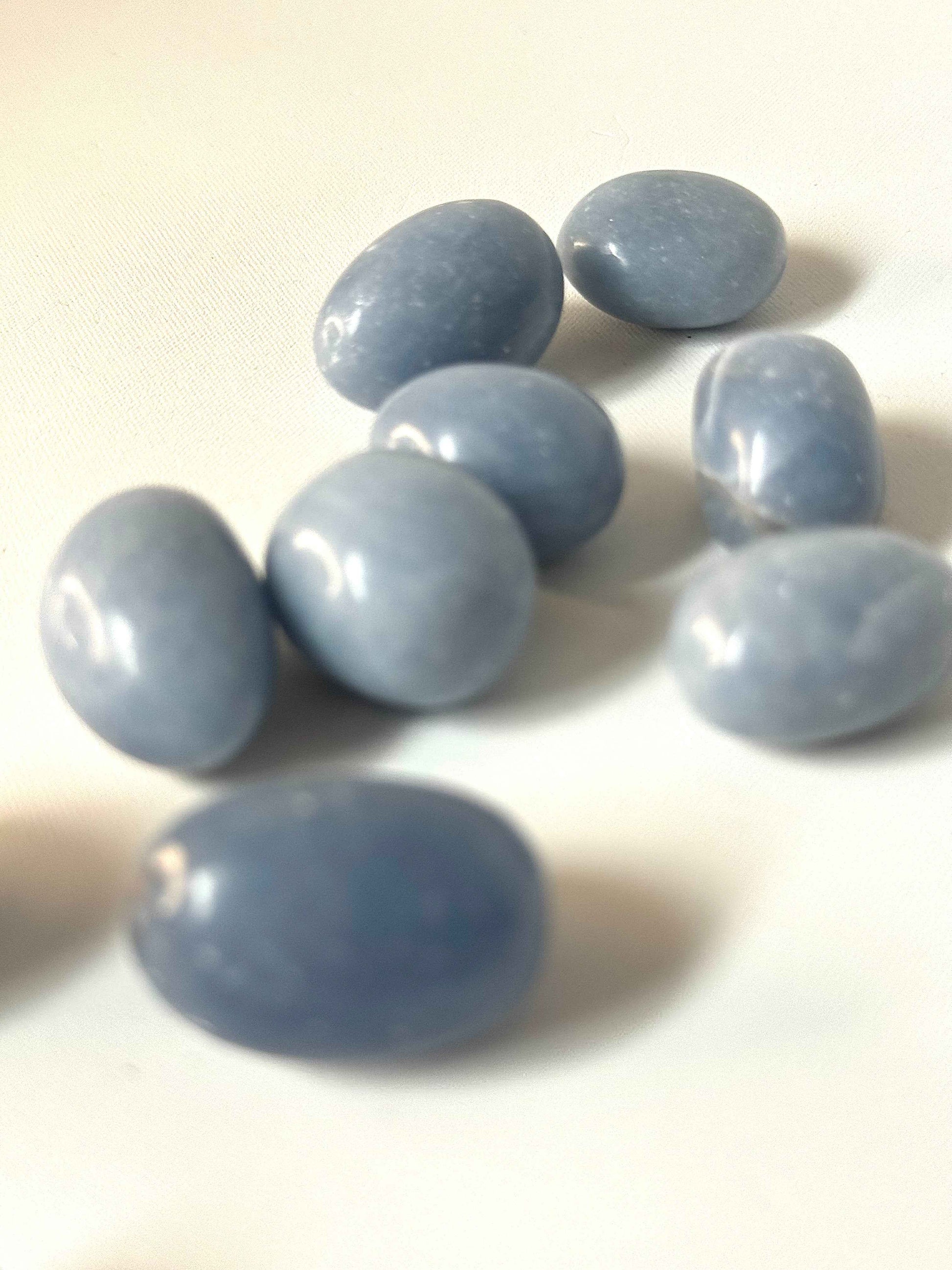 Angelite Crystal Stones - Communication | Serenity | Growth | Peace. Close-up of smooth Angelite tumble stones ideal for meditation and holistic wellness.