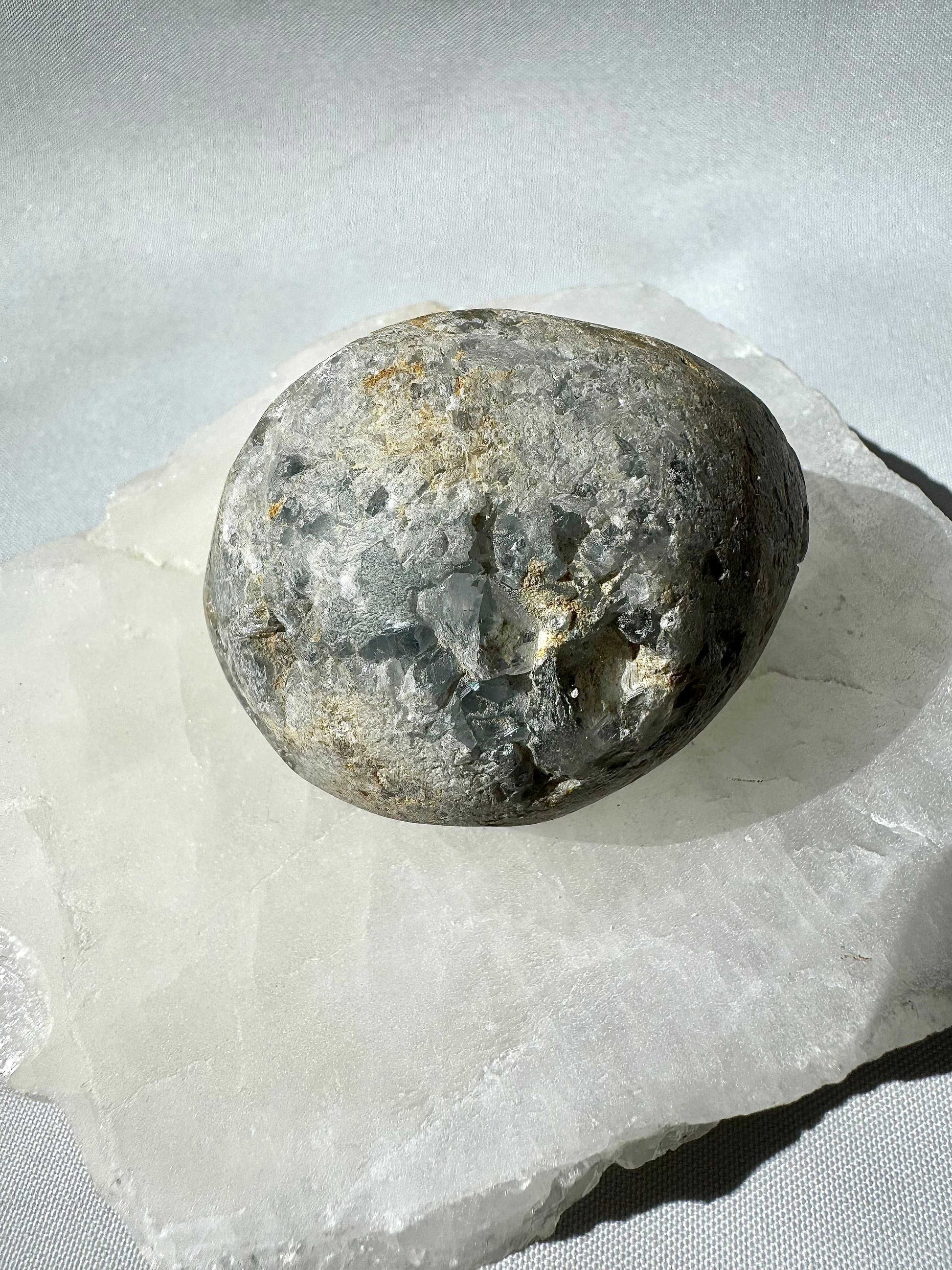 Back view of Celestite Cluster #5 showing natural stone matrix, highlighting its raw, collectible form for crystal enthusiasts and collectors.