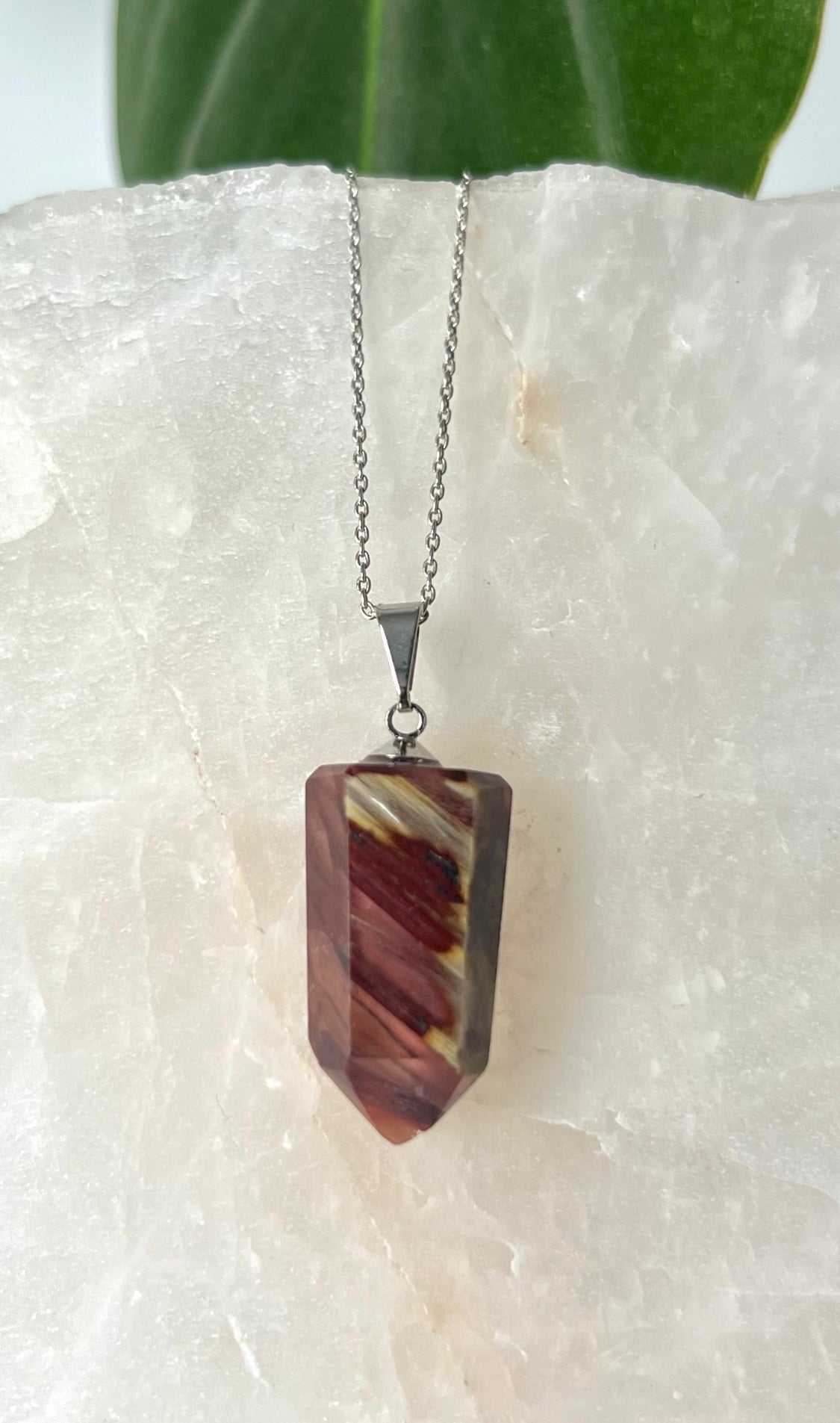 Red Amphibole Quartz Pendant with silver bail, showcasing unique crystal patterns for spiritual balance and protection.