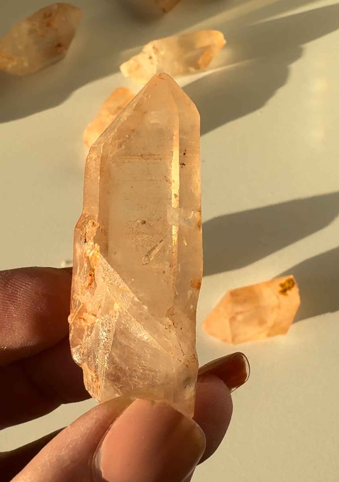 Detailed view of Lemurian Tangerine Crystal Quartz | Bespoke Crystals with natural facets and iron deposits, ideal for crystal healing or collection.