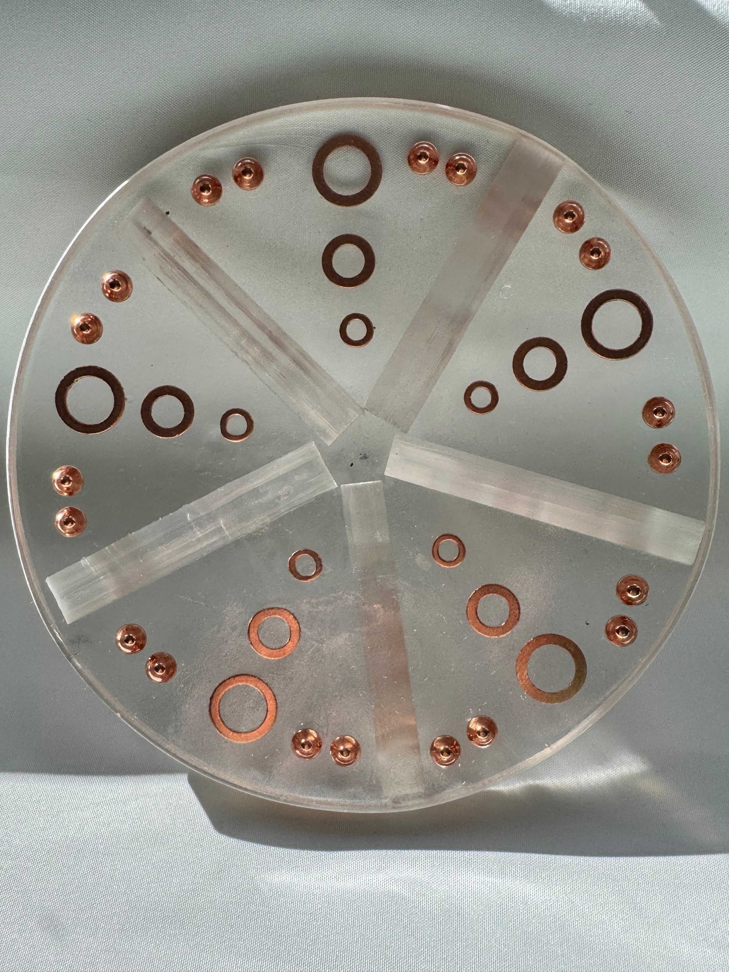 Back view of a round Selenite crystal charging plate with copper details for energy reset | Online crystals NZ