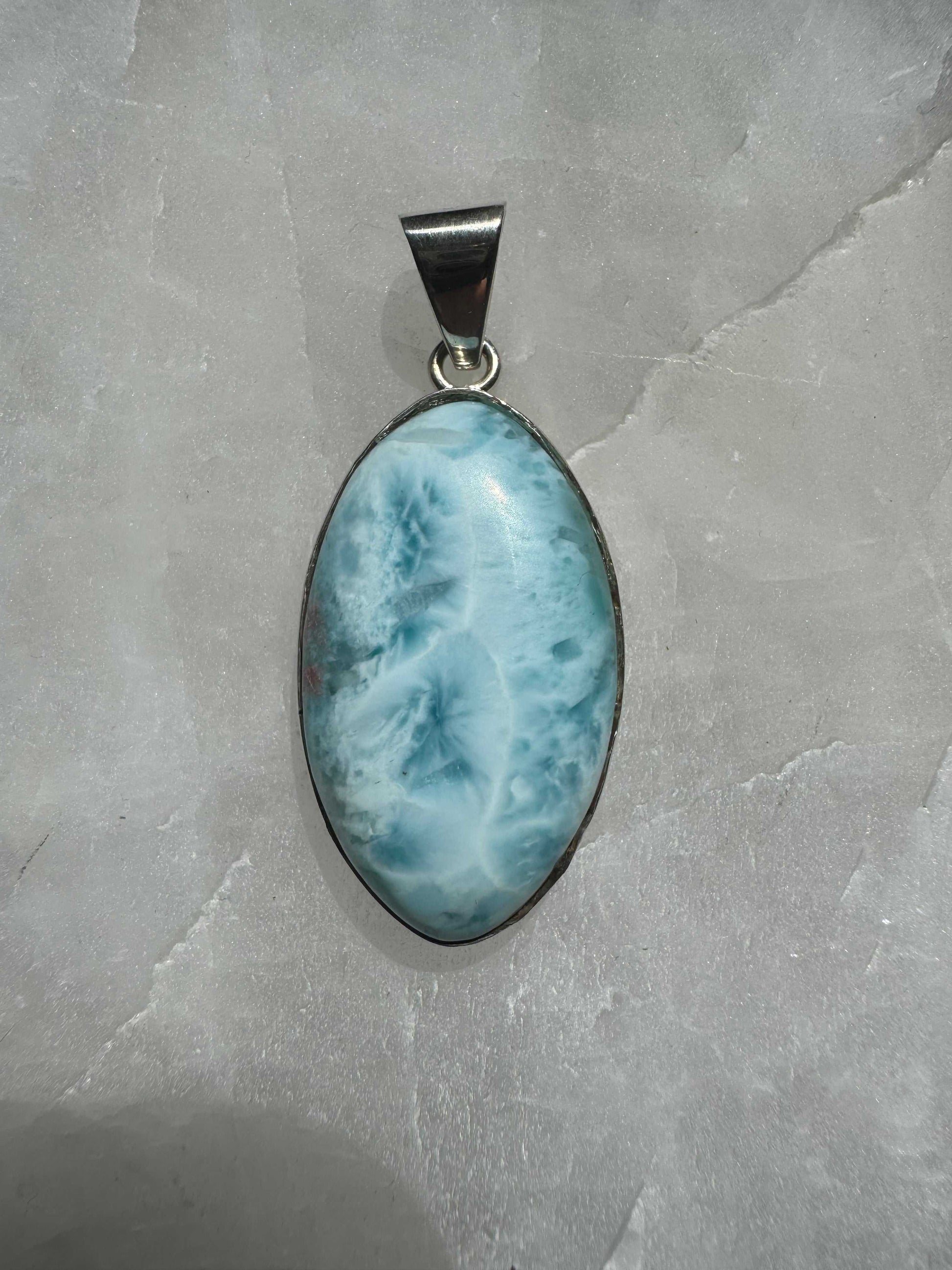 Close-up of Larimar Crystal Pendant - Peace & Clarity with intricate blue patterns and polished silver frame, ideal for crystal jewellery lovers in NZ.