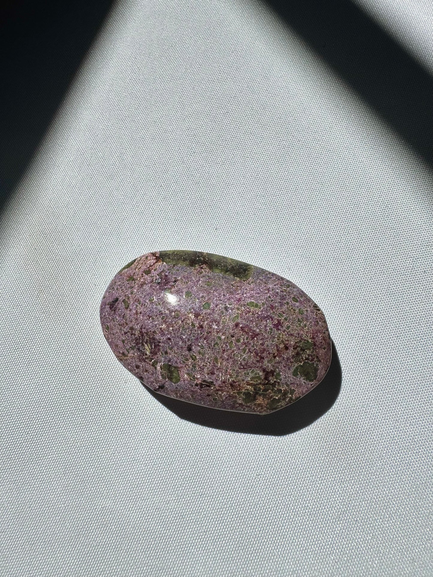 Smooth Atlantisite Crystal Palm Stone with fine-grained purple and green texture, ideal for collectors of rare healing stones.