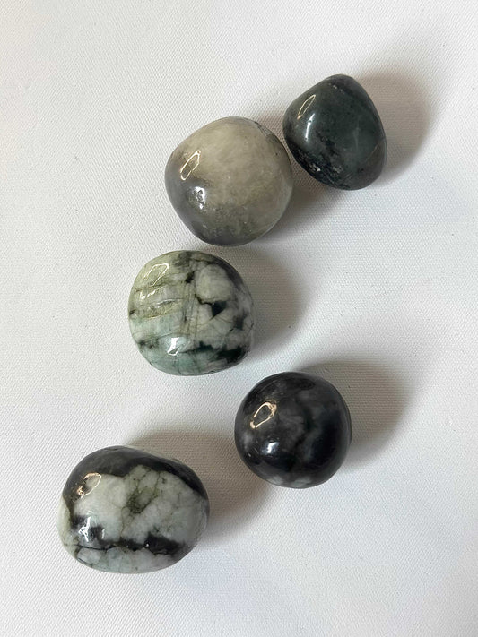 Emerald Crystal Tumble Stone | Bespoke Crystals featuring five polished green and black stones on white background, ideal for collectors.