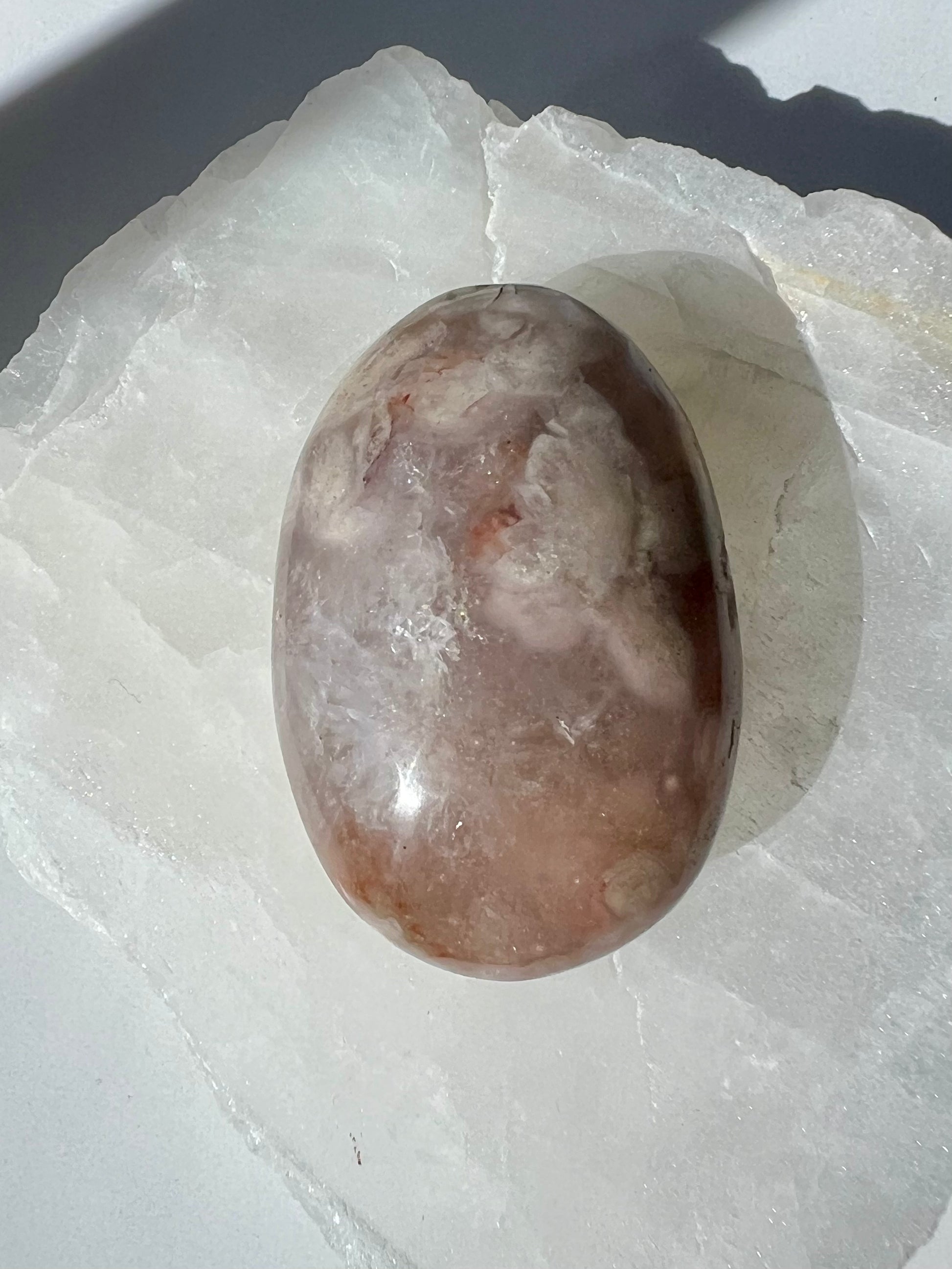 Smooth Flower Agate Crystal Palm Stone with cloudy patterns and warm tones, perfect for nurturing energy and spiritual growth in crystal collections.
