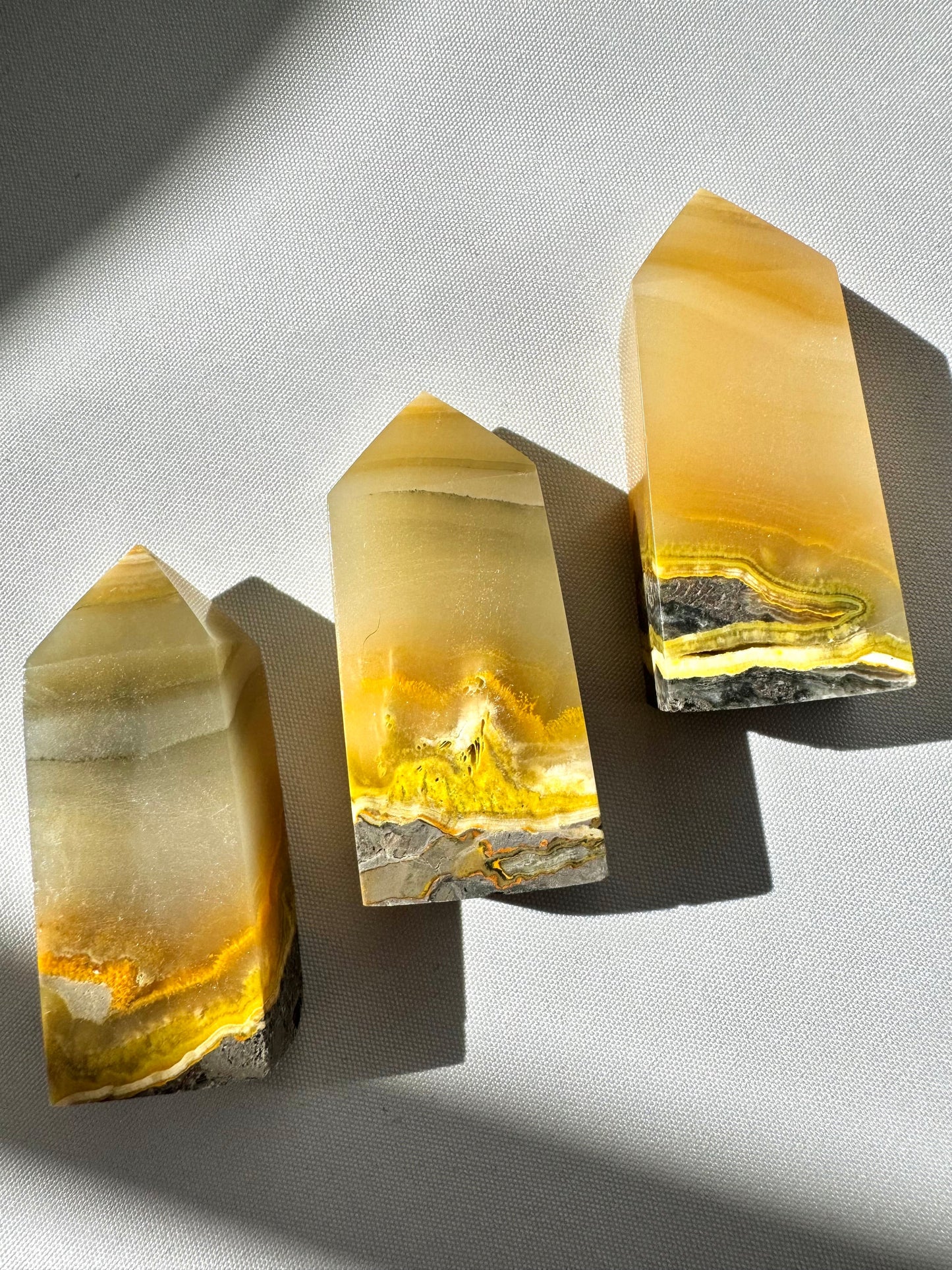 Bumblebee Jasper Crystal Tower | Bespoke Crystals featuring three upright yellow and grey mini towers with vibrant bandin