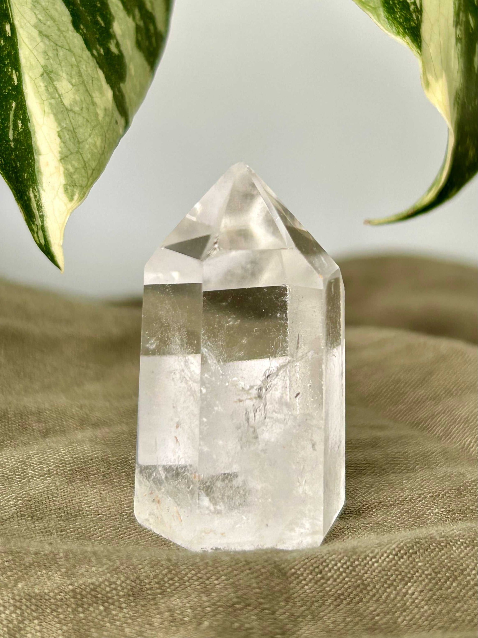 Mini Quartz Crystal Tower Brazil with polished facets and pointed tip, ideal for chakra healing and spiritual energy work in bespoke crystal NZ collections.