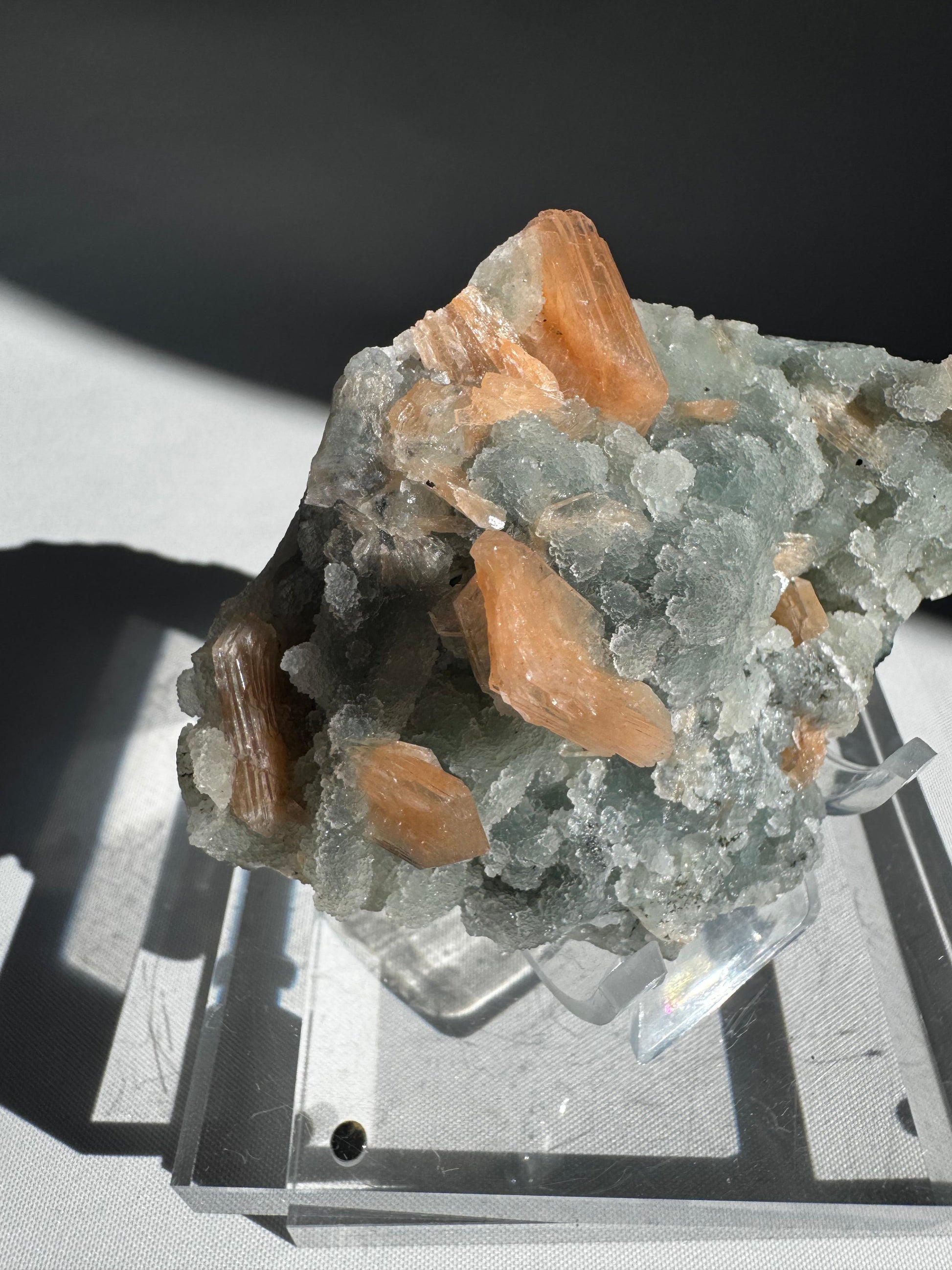 Side angle of Chalcedony with Orange Stilbite Crystal #5 highlighting lustrous orange Stilbite crystals embedded in a pale Chalcedony structure.
