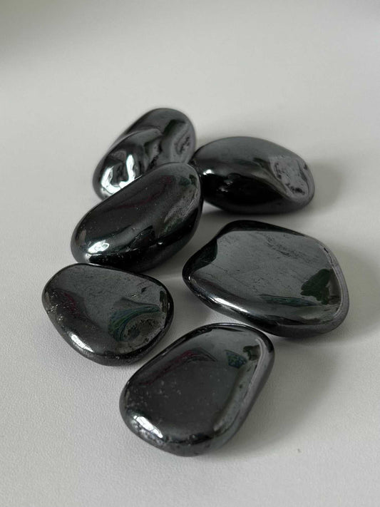 Large Bespoke Hematite Tumble Stones with a glossy finish, ideal for grounding and root chakra healing in crystal collections.
