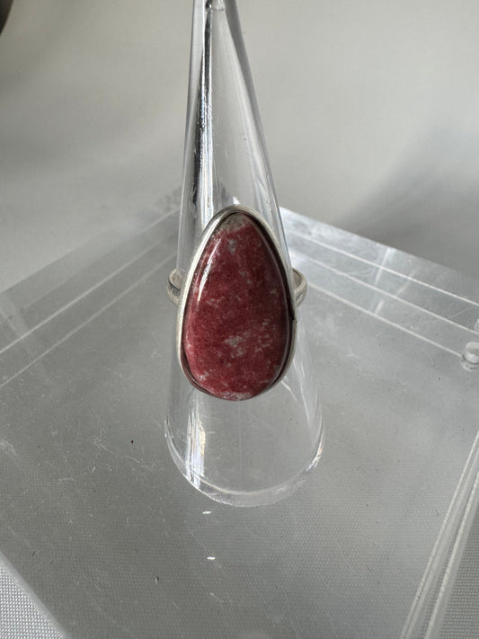 Thulite Crystal Ring | Bespoke Crystals featuring a teardrop-shaped pink Thulite stone set in sterling silver, displayed on a clear stand.