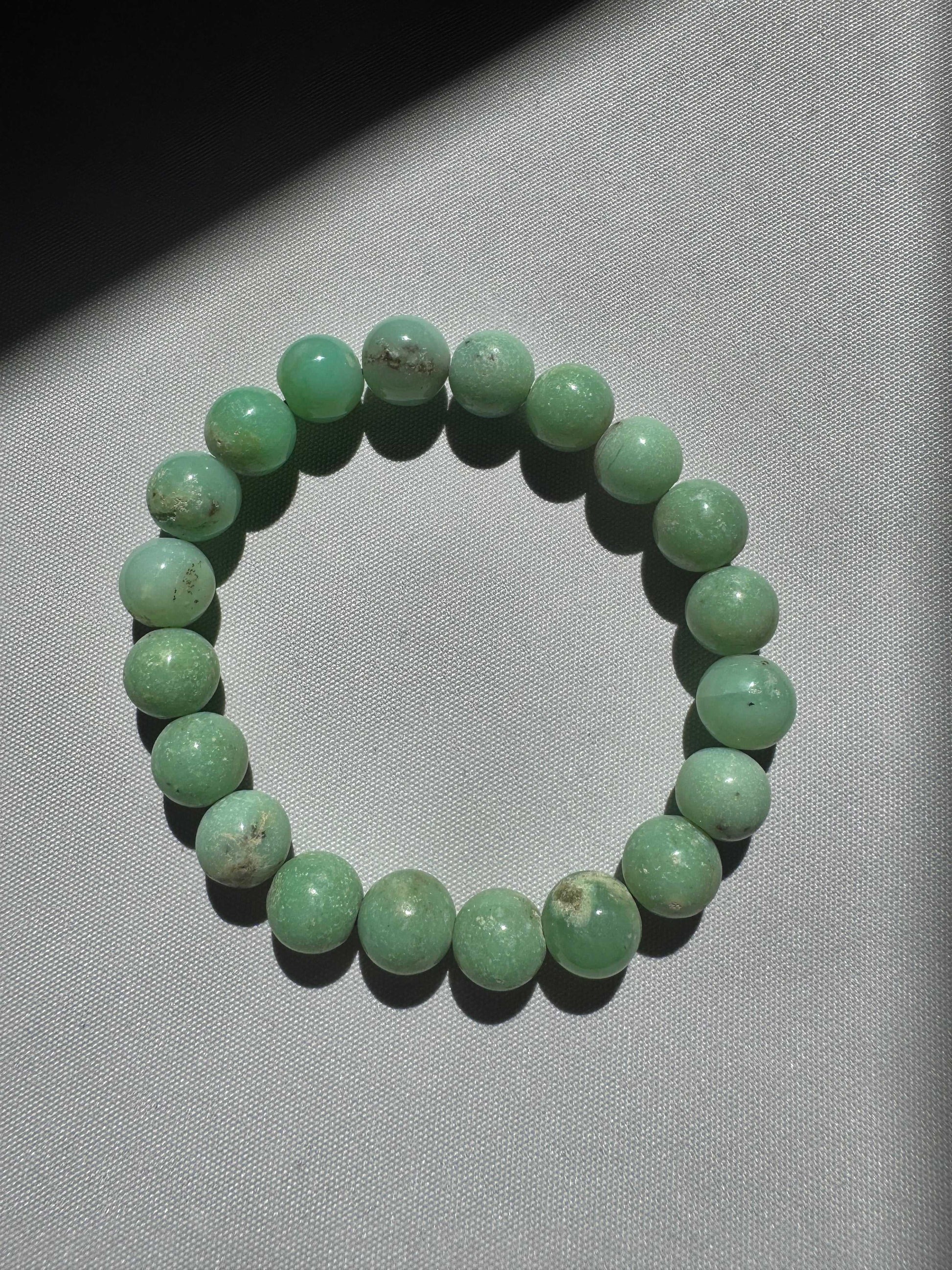 Single strand Chrysoprase Crystal Bracelet 10mm with smooth green beads, perfect for elegant styling and crystal healing benefits.