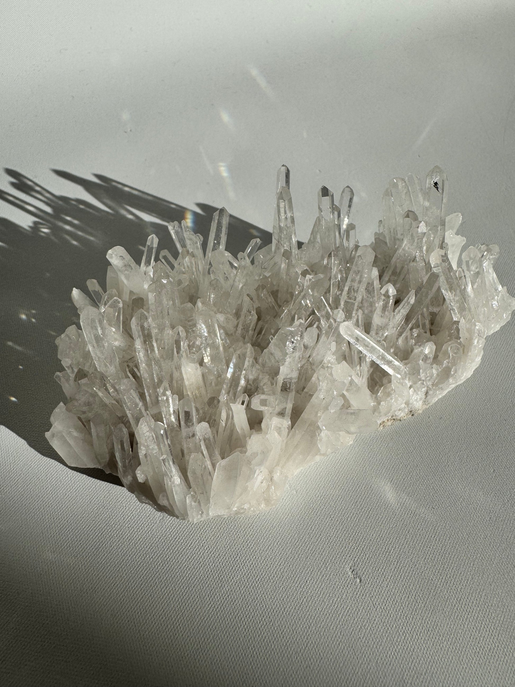 Wide view of Needle Quartz Crystal Cluster with radiant quartz spikes, showcasing its natural volcanic origin and collectible appeal.