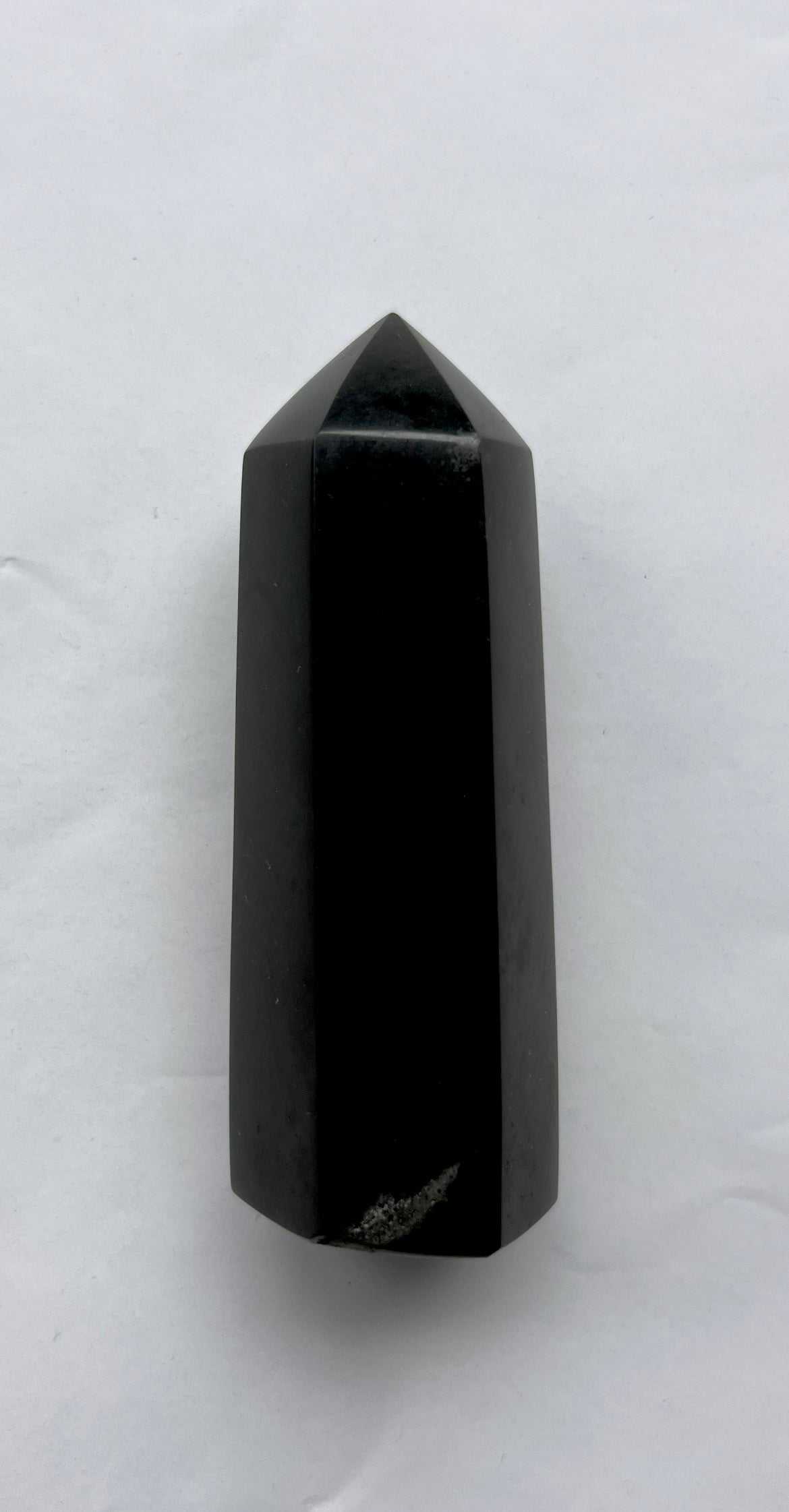 Polished Black Tourmaline Tower - Protection Stone shown on white background, ideal for spiritual balance and energy shielding.