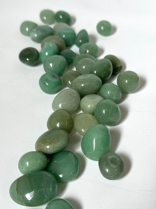 Green Aventurine Tumble Stones | Bespoke Crystals scattered on white background, ideal for manifestation and crystal healing collections.