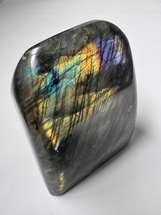 Labradorite Crystal Freeform A04 with vibrant blue, gold, and purple flashes, ideal for collectors and spiritual healing. Unique polished stone from Bespoke Crystals.