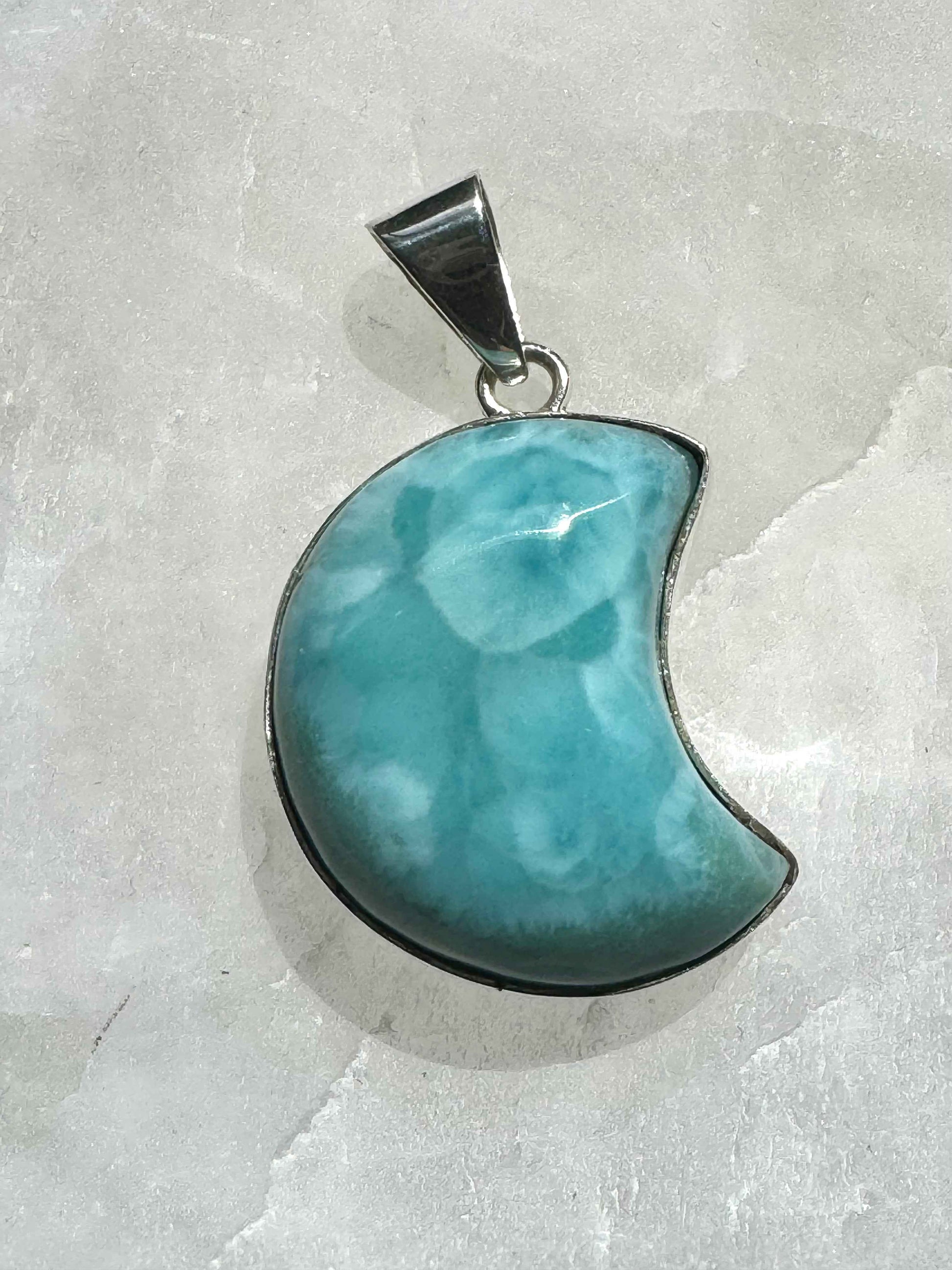 Larimar Pendant | Bespoke Crystals in crescent moon shape, featuring vibrant ocean-blue tones and 925 sterling silver frame.