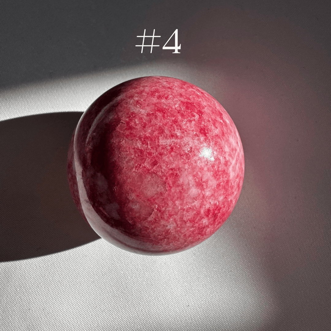 Pink Thulite Crystal Sphere #4 with a smooth finish and rich pink coloration, ideal for collectors and crystal enthusiasts seeking optimism and love energy.