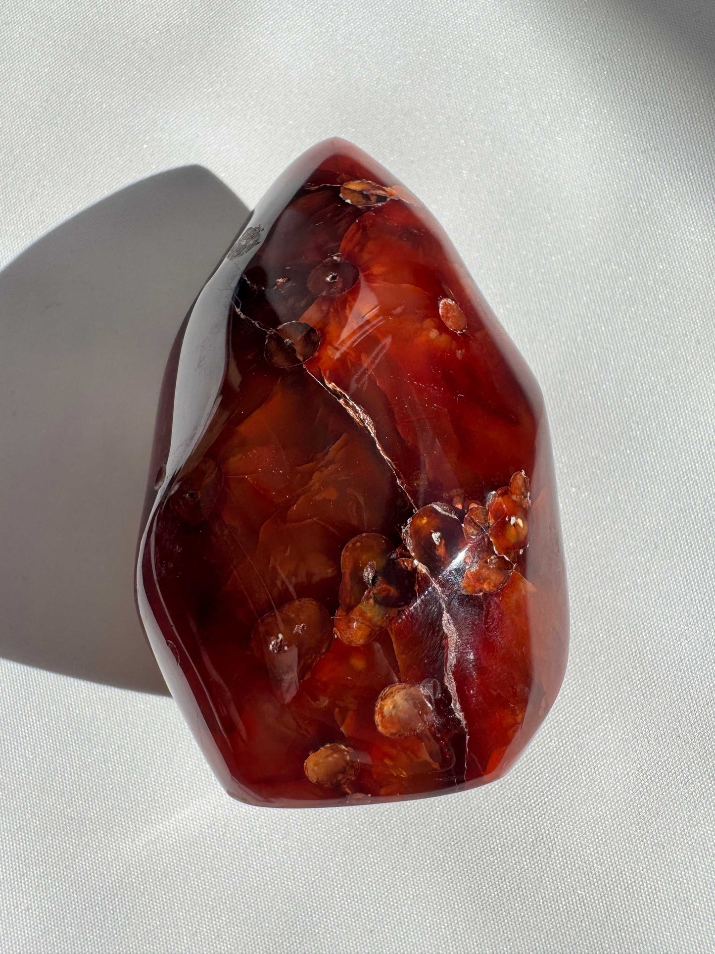 Polished Carnelian Flame Crystal featuring natural inclusions and rich orange-red tones, perfect for enhancing energy and passion in crystal healing.
