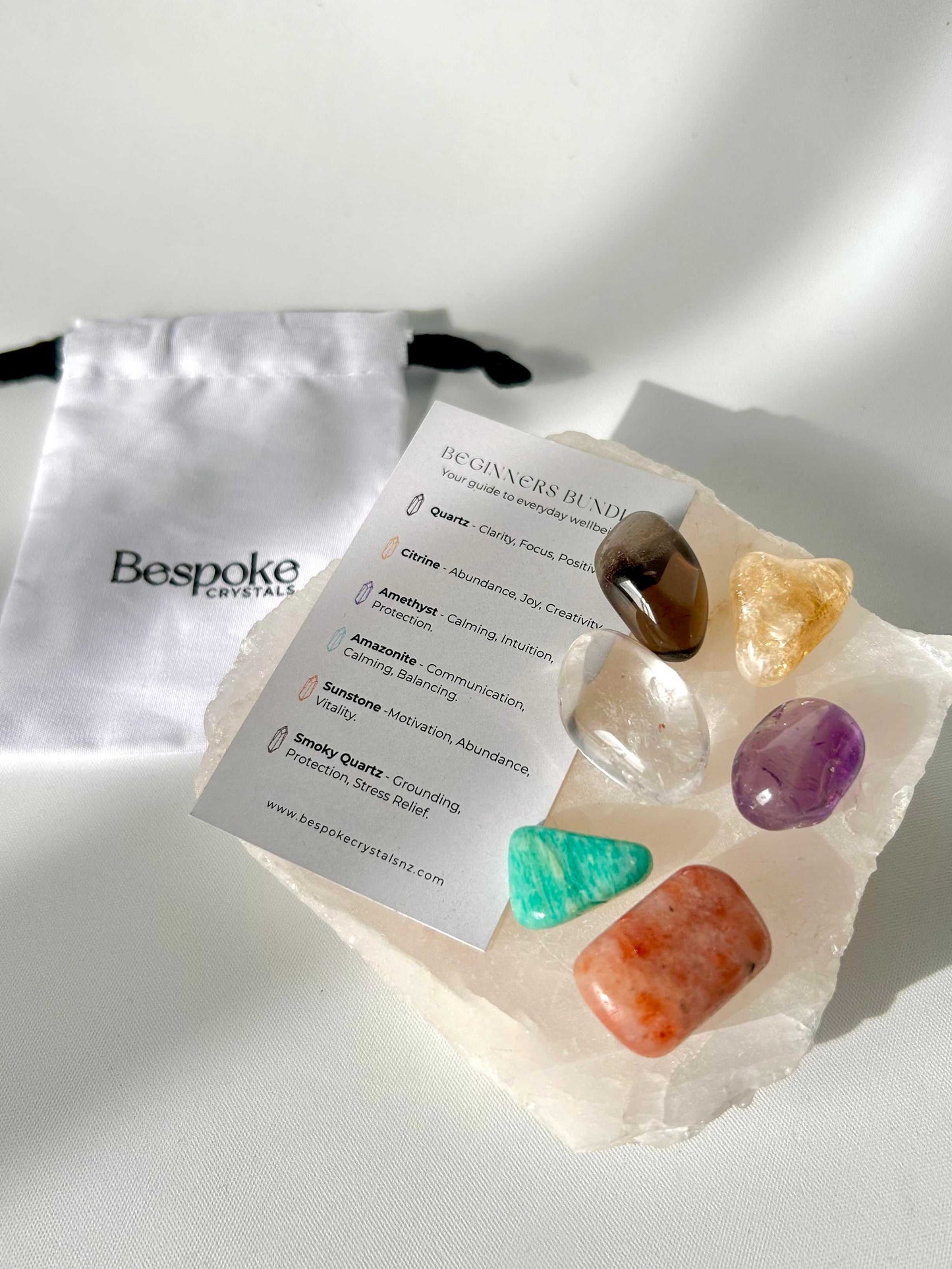 Bespoke Crystals Beginners Bundle with labeled guide card and pouch, showcasing healing stones for clarity, transformation, and well-being.