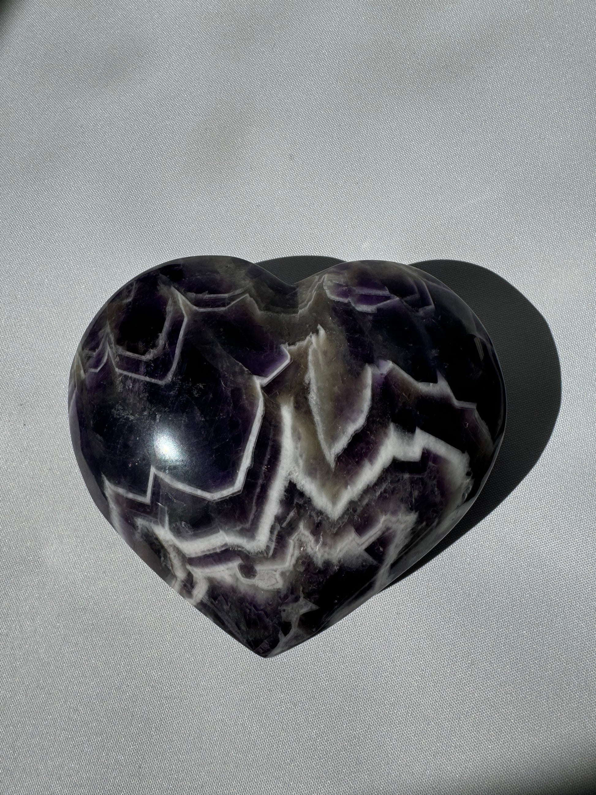Polished Large Chevron Amethyst Crystal Heart showcasing intricate purple and milky quartz patterns, perfect for rock and fossil collections.