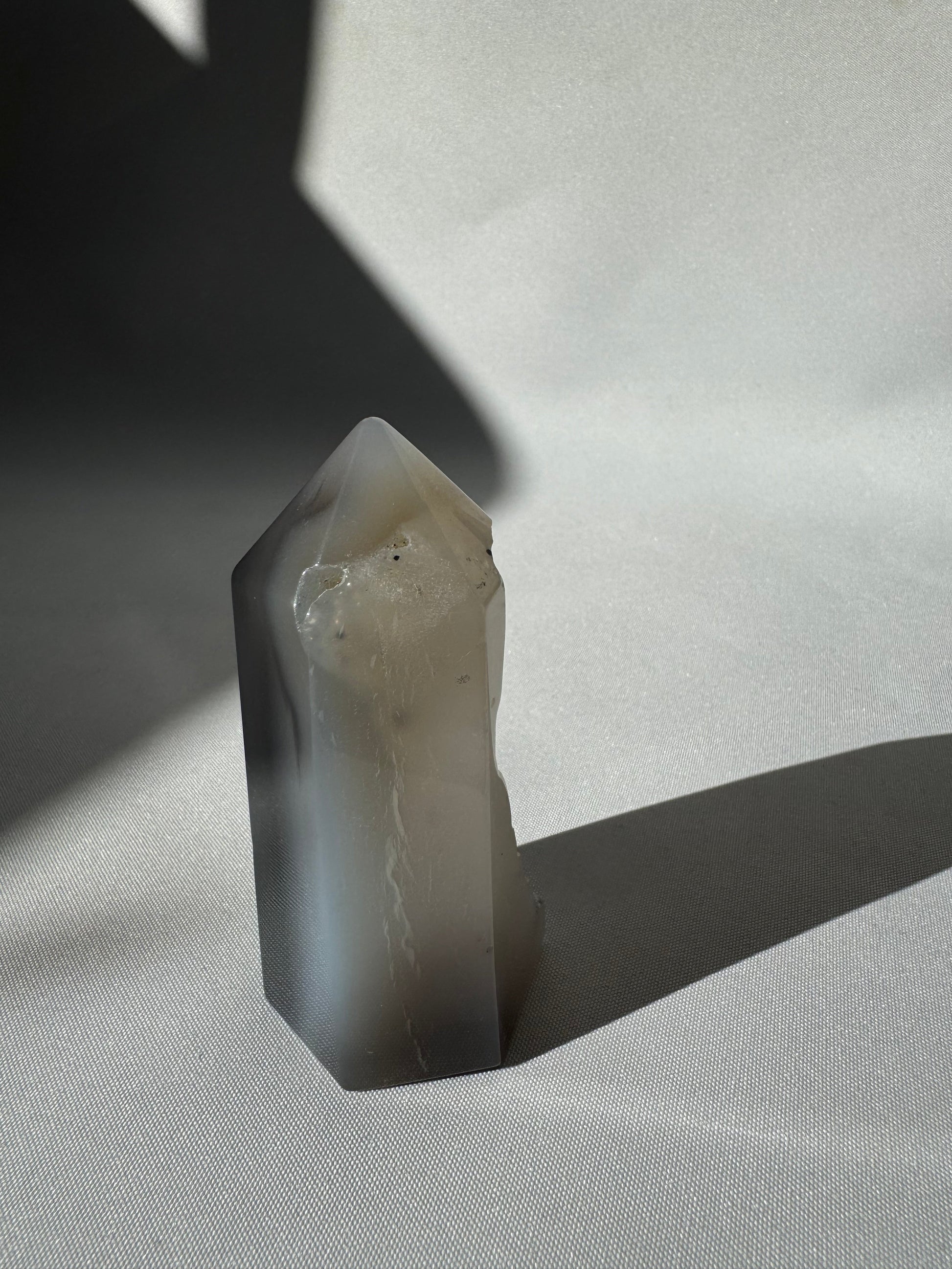 Side view of Agate Crystal Druze Point #1 showing translucent grey tones and subtle natural inclusions, a unique piece for crystal lovers.