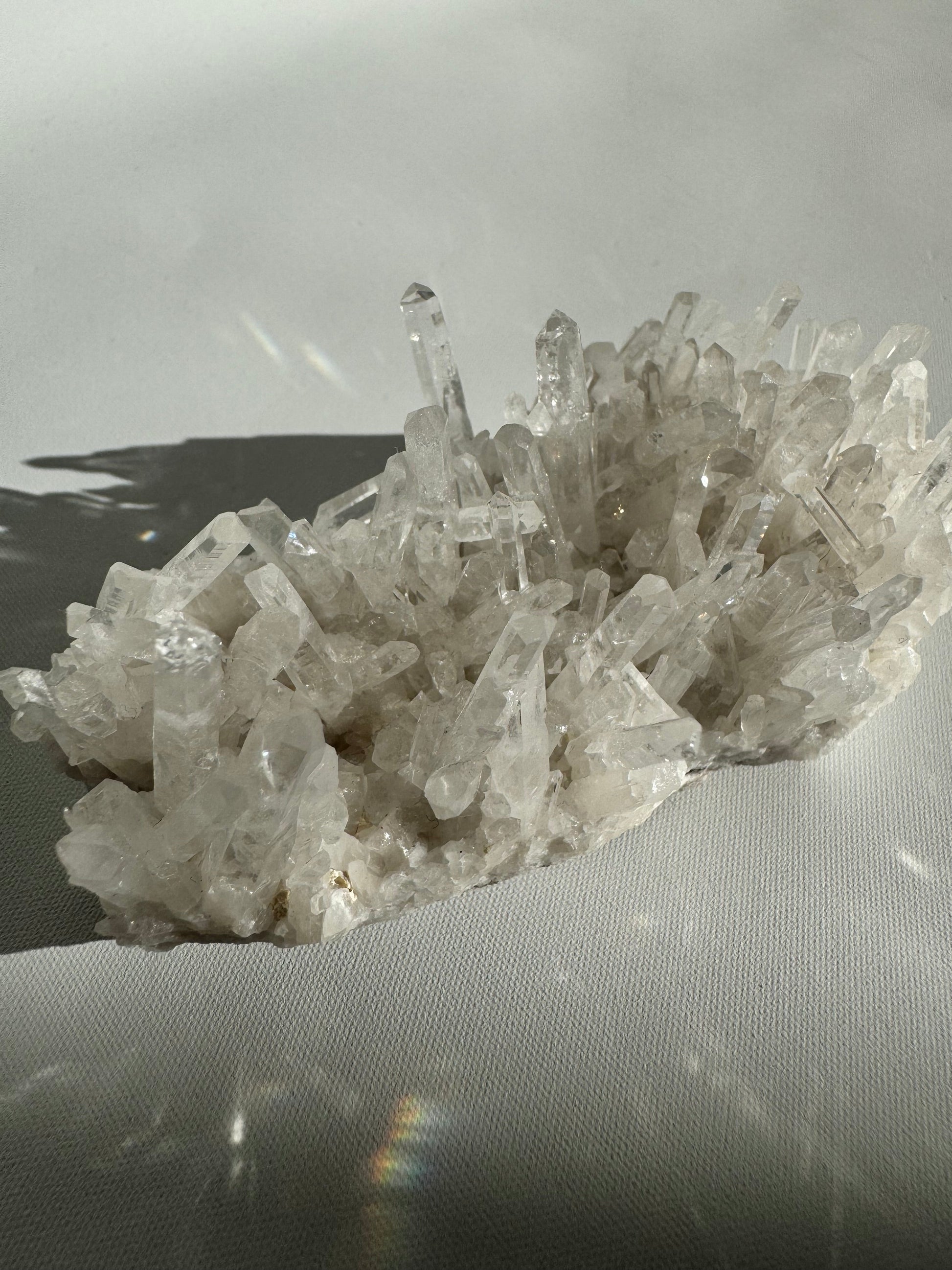 Side view of Needle Quartz Crystal Cluster showing sharp, transparent needle-like formations, perfect for display in rock and fossil collections.