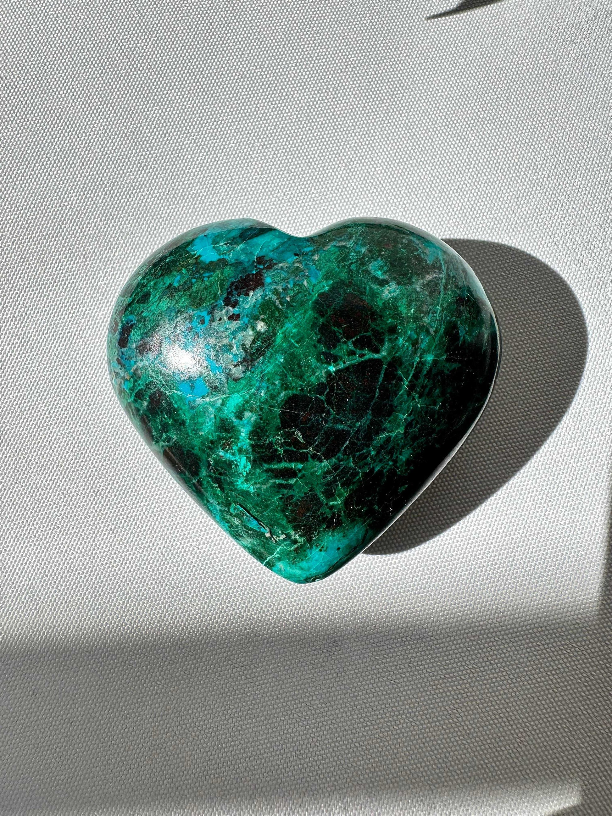 Malacolla Crystal Heart #4 | Bespoke Crystals shown under natural light, highlighting its vivid green, turquoise, and brown hues in a heart-shaped form.