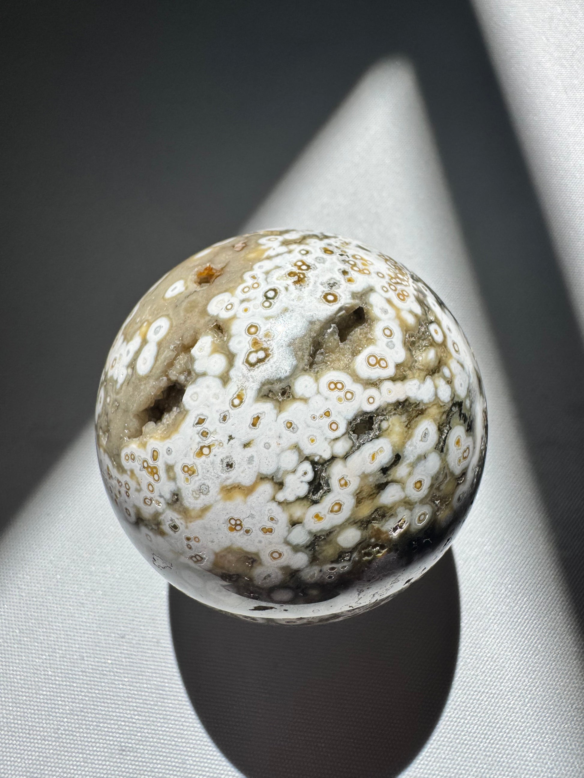 Polished Orbicular Ocean Jasper Sphere #3 featuring white and olive green orb formations with golden accents. Unique natural stone for crafts or decor |Bespoke Crystals