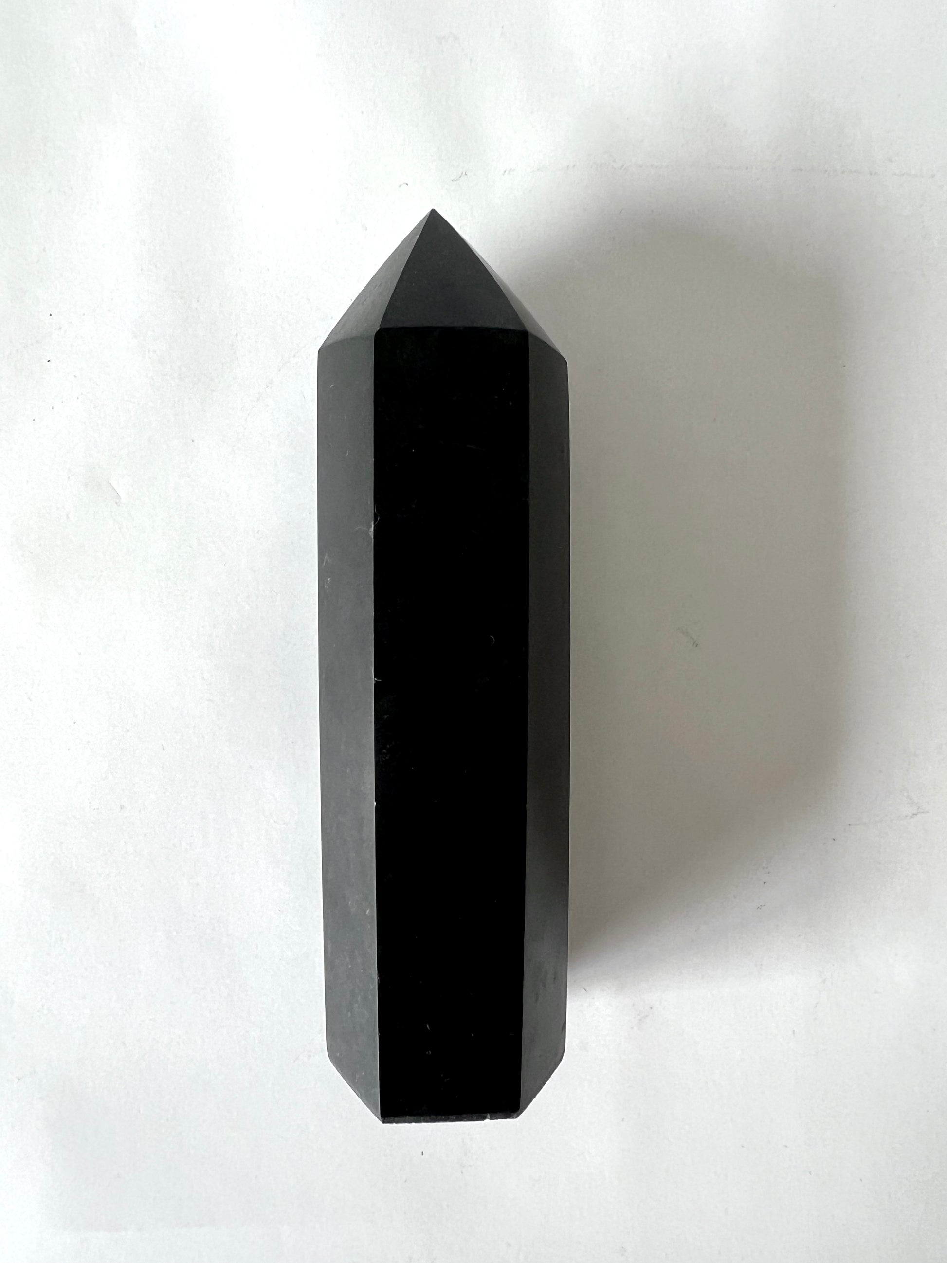 Black Tourmaline Tower - Spiritual Protective Crystal with polished hexagonal point, ideal for aura cleansing and energy shielding rituals.