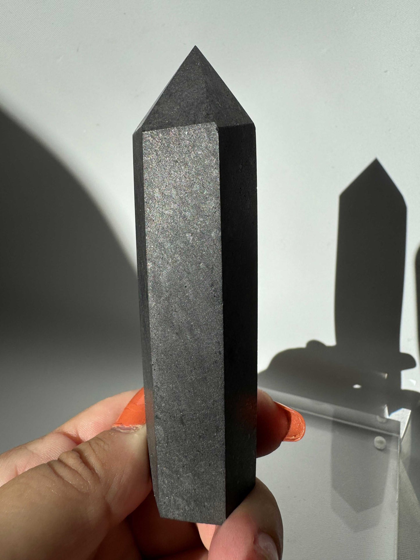 Shungite Crystal Point | Bespoke Crystals | polished hexagonal shape and deep black surface for grounding energy.
