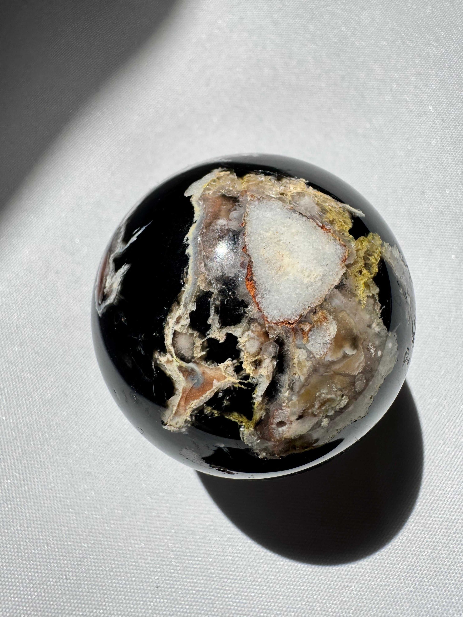 Black Flower Agate Sphere with white and earthy mineral inclusions, ideal for meditation and healing in rock and fossil collections | Crystals Online NZ