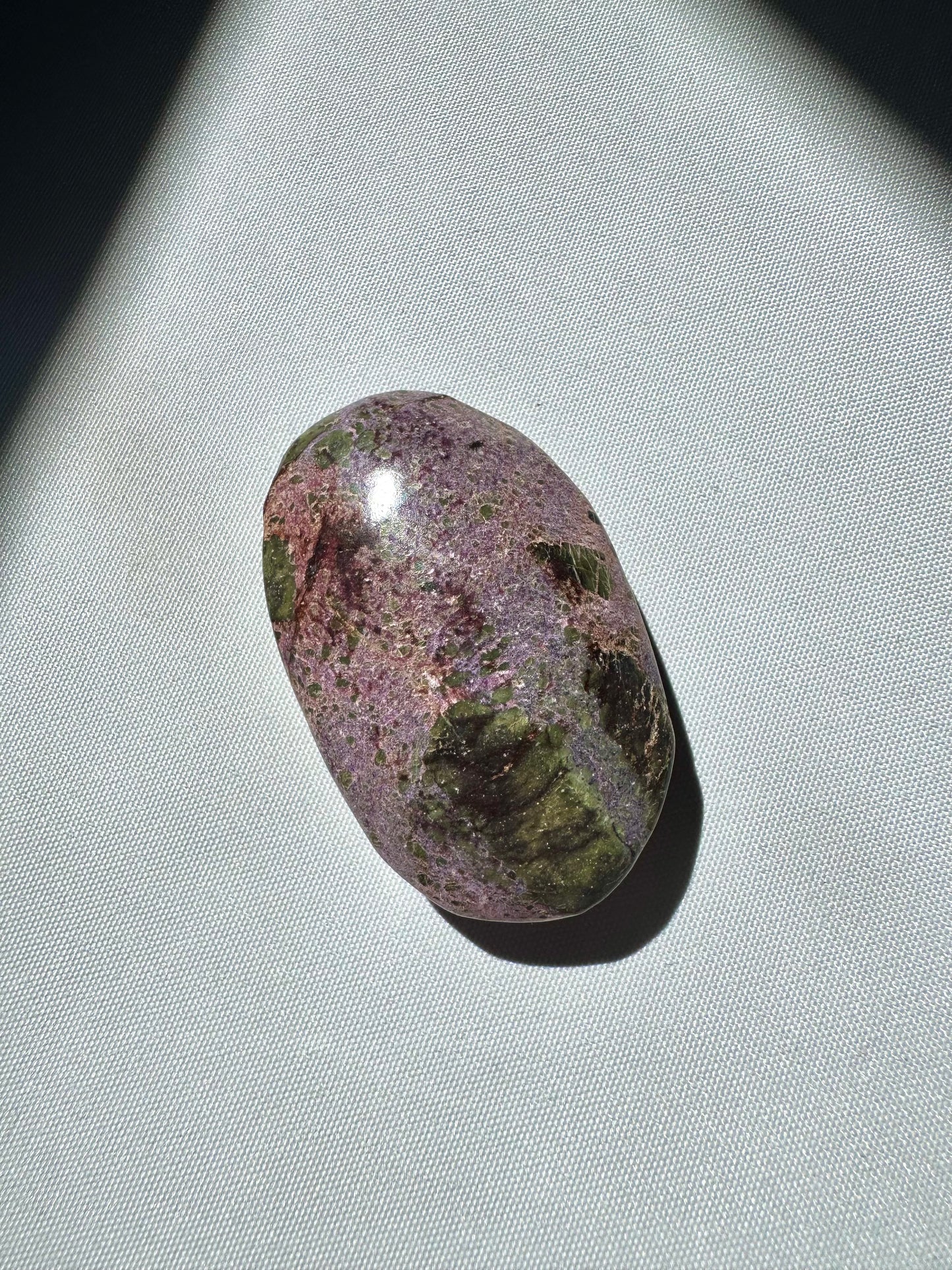 Compact Atlantisite Crystal Palm Stone with speckled purple and green surface, a bespoke crystal for emotional healing.