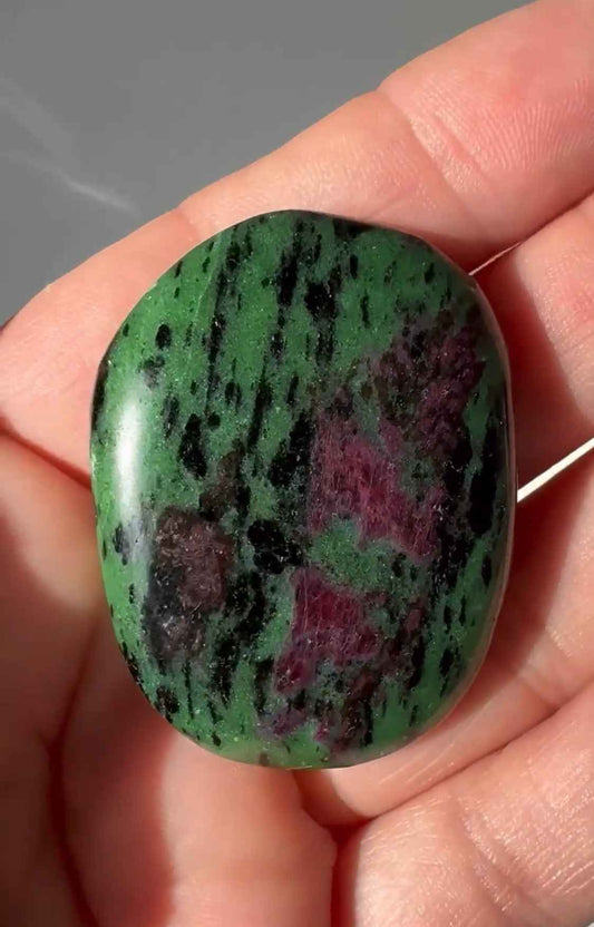 Polished Ruby Zoisite Crystal Flat Stone with vibrant green, black, and ruby-red hues, ideal for pocket carrying and crystal healing.