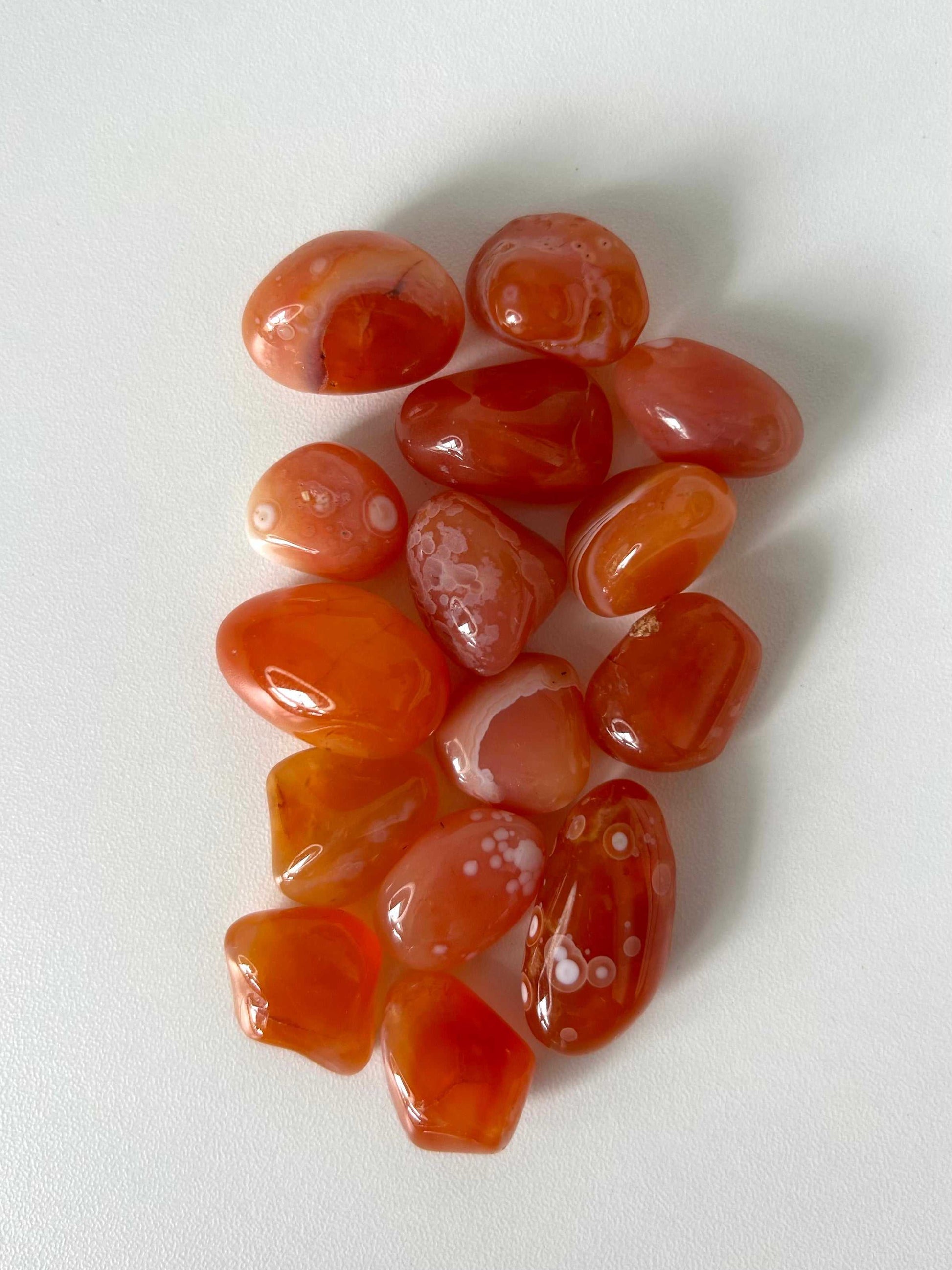 Carnelian Banded Eye Tumble Stones with unique white band patterns, ideal for enhancing creativity and sacral chakra balance in crystal collections.