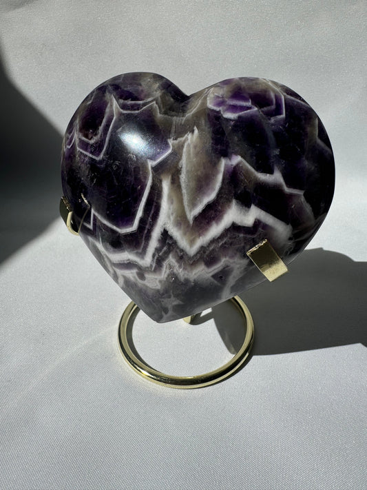 Large Chevron Amethyst Crystal Heart on gold stand with vivid purple and white banding, ideal for collectors and spiritual decor.