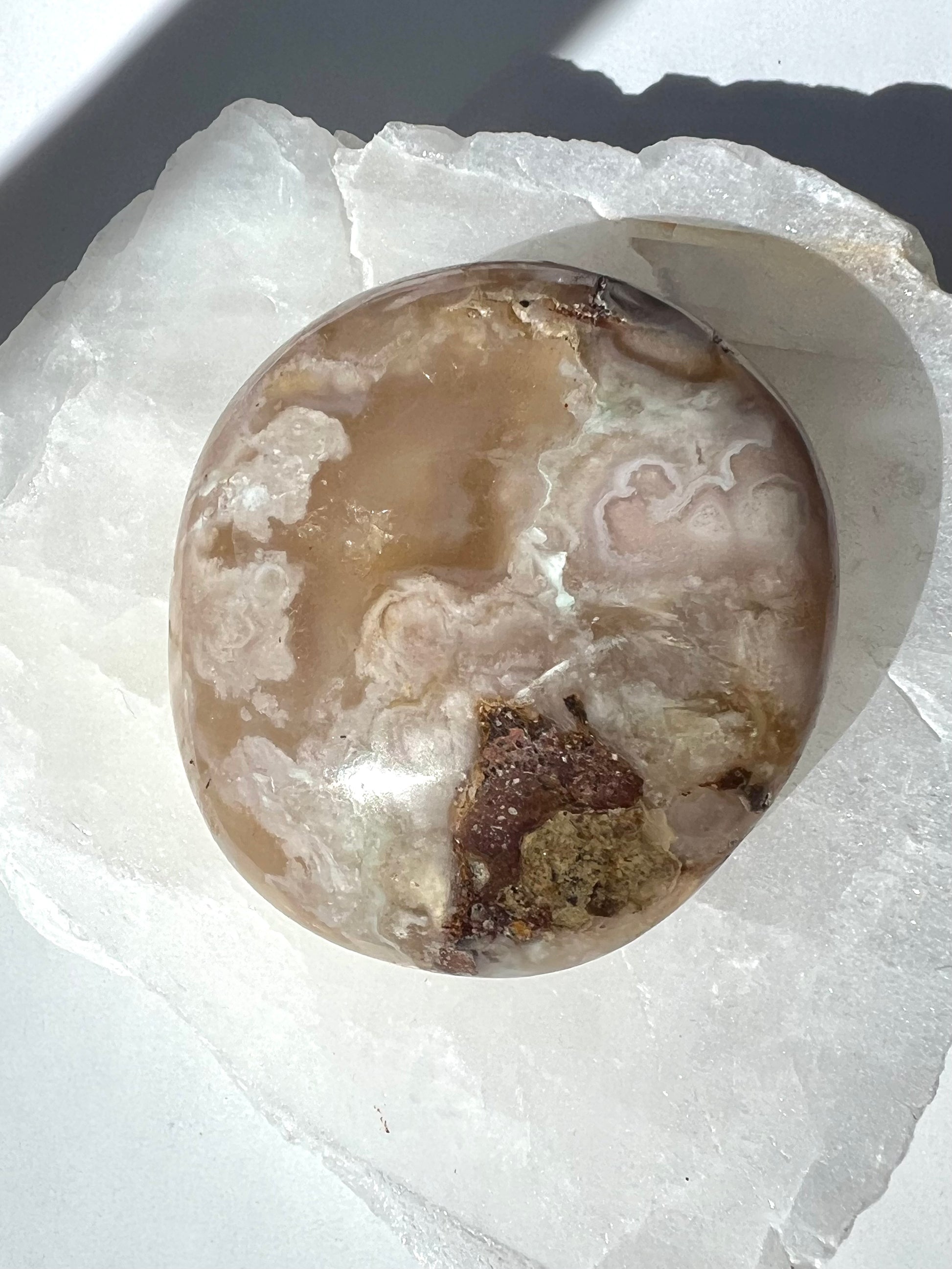 Polished Flower Agate Crystal Palm Stone with soft pink and beige floral patterns, ideal for healing and transformation. Available at Bespoke Crystals Auckland New Zealand
