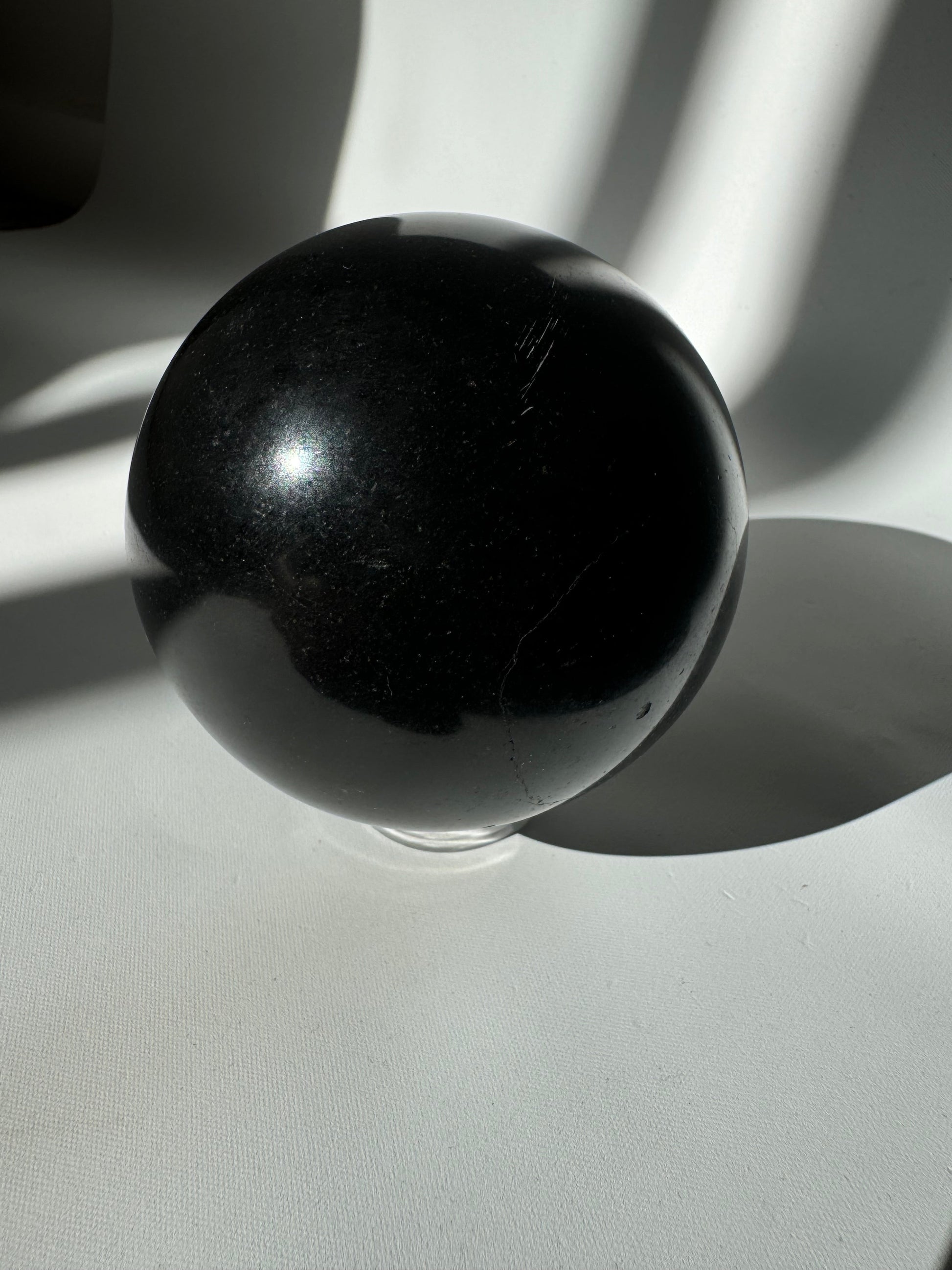 Black Tourmaline Crystal Sphere #3 displayed on white background, a bespoke crystal for self-confidence and protective energy.