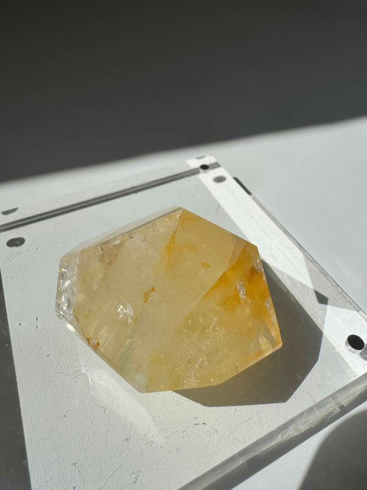 Golden Healer Crystal Freeform quartz with iron oxide inclusions, emitting a warm glow, perfect for collectors and spiritual energy work.