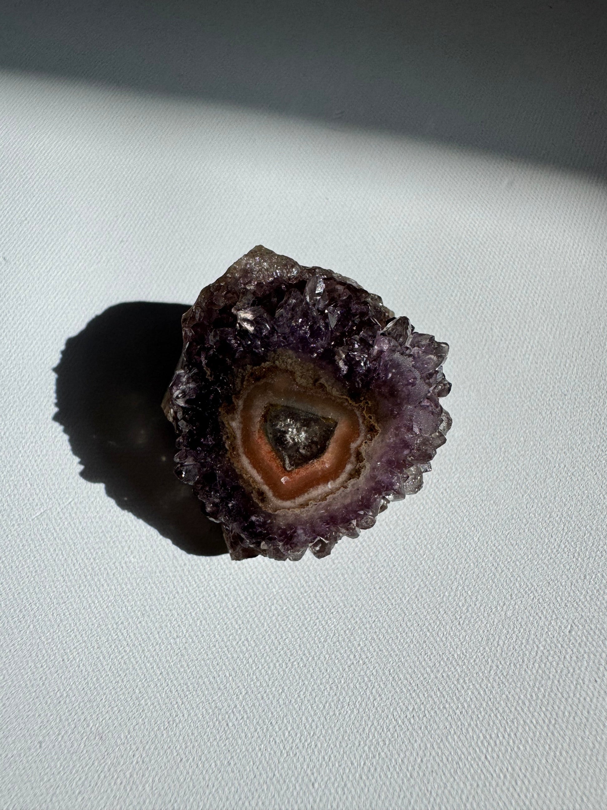 Heart-shaped Amethyst Crystal Stalactite Grade A with layered pink and purple tones, a rare and beautiful rock specimen for display.